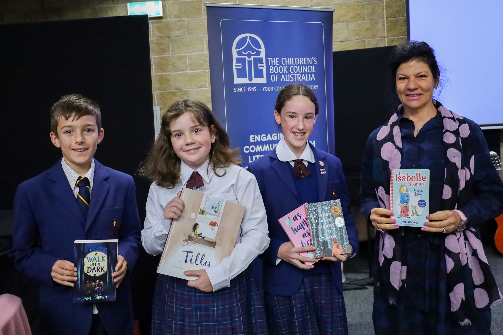 Year five students Sidney Box, Mabel Larkins and Eloise Gorton with Jane Godwin.
