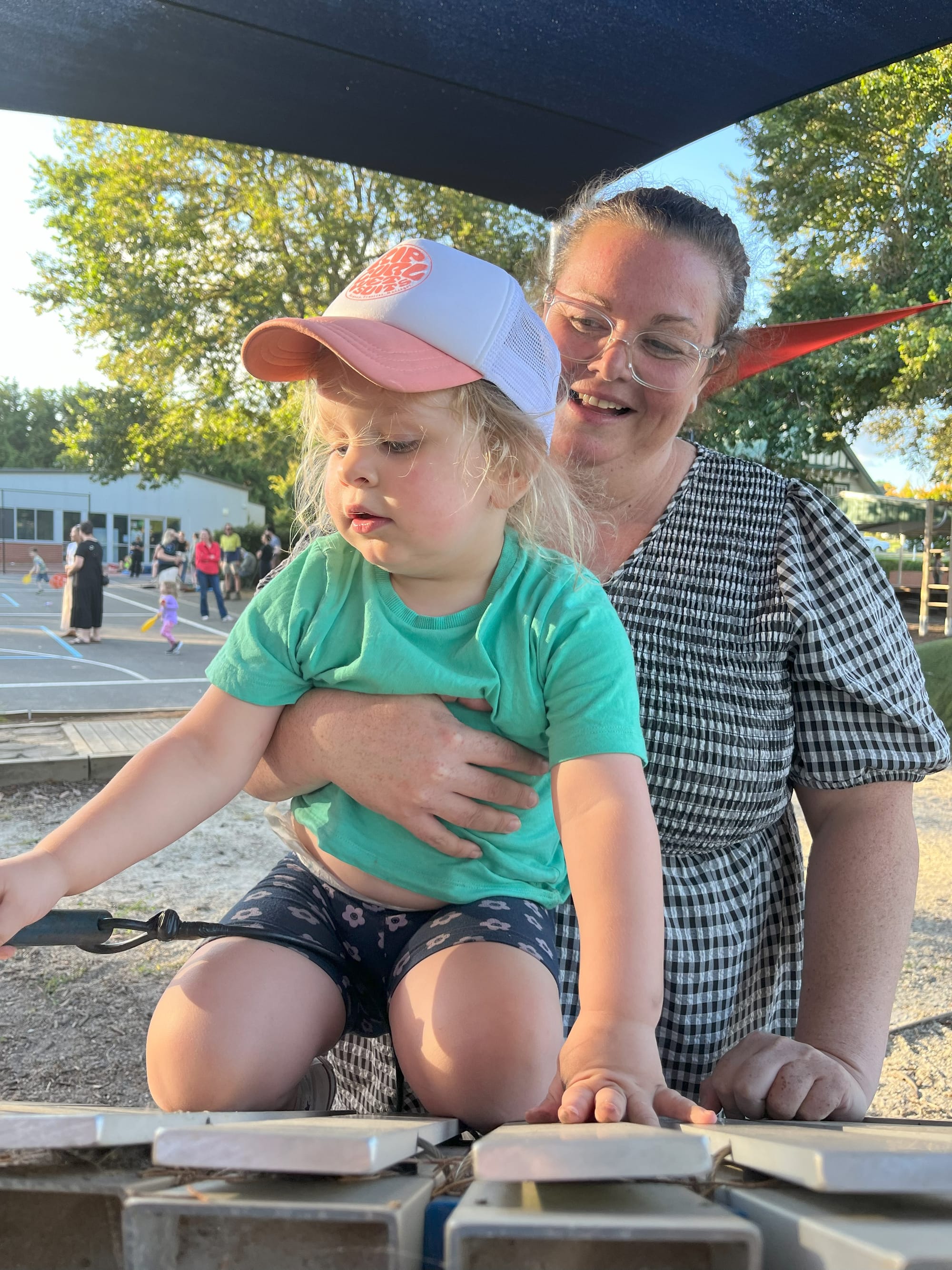 Kim Weller and her daughter Lenni practice their musical skills in the playground.