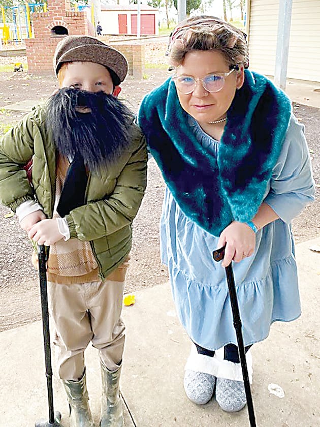 Using their canes to walk around are Jack Towt and education support staff member Emily Kemp.