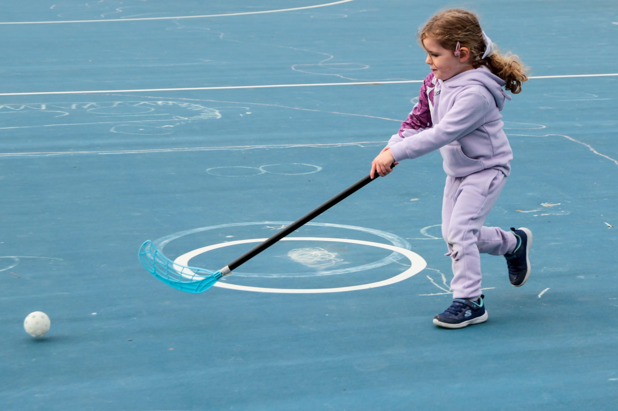 Anna Bruce concentrates with both hands on the hockey stick.