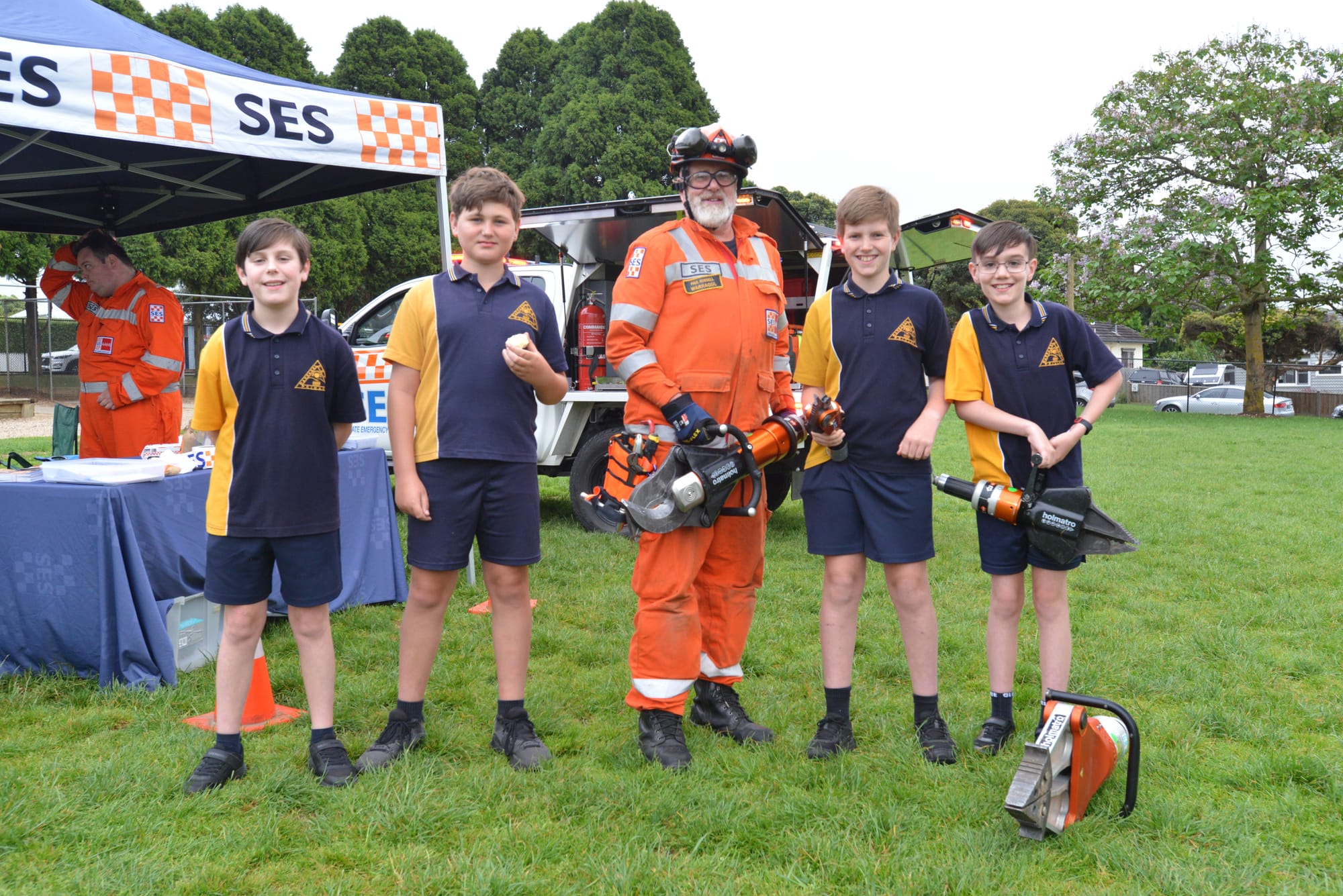 Warragul SES volunteer Paul Russell offers a close look at some equipment to encourage future generations of volunteers. The students are (from left) Tom Searle, Will Hughes, Jack Bucknall and Alex Thomas.