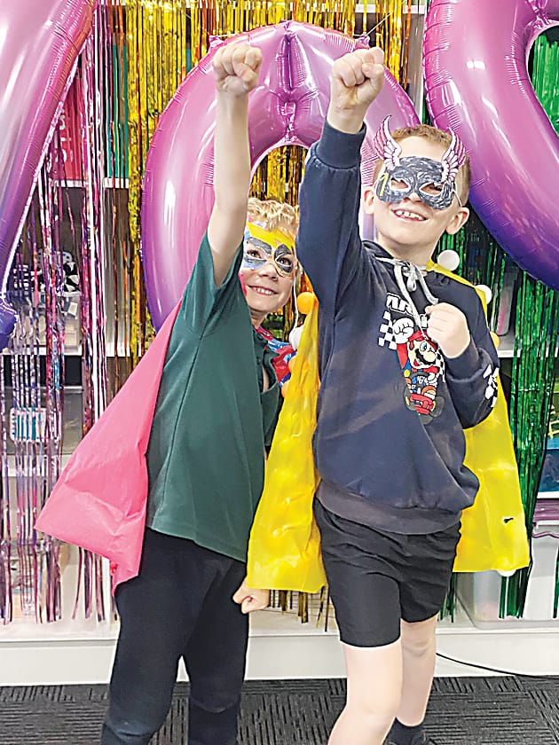 Above: Eli and Jack enjoying being 100 day heroes.Left: Stella and Alexis dressed up for 100 days of school.