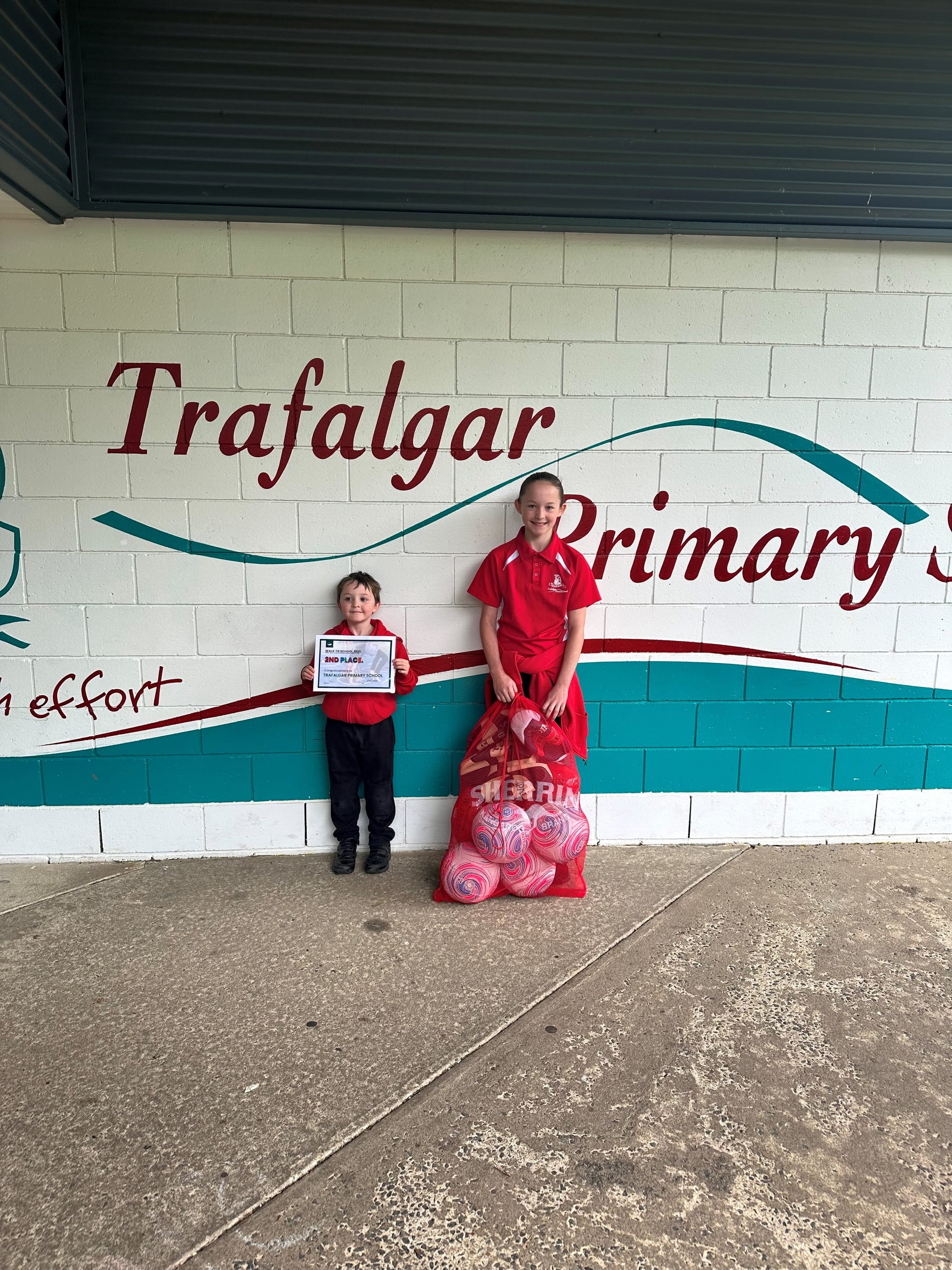 All smiles to receive a sports equipment boost at Trafalgar Primary School as part of the local Walk to School Week campaign are Ollie Hill and Aurora Coffee.