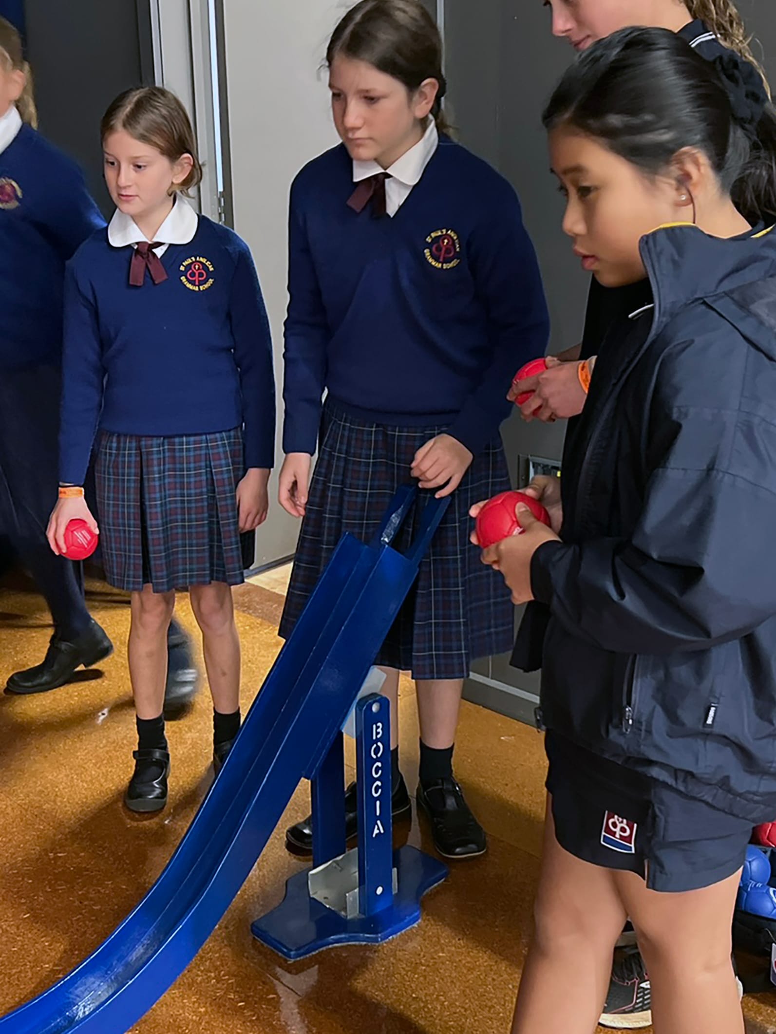 Experiencing how activities can be modified for community inclusiveness are St Pauls students Isla Madden, Charlotte Muir and Melina Mai.
