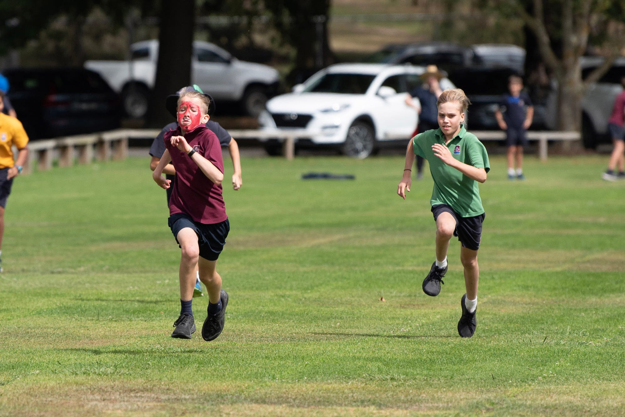 Racing to the finish in the 100m race are Joe McInerney and Nathan Brown.