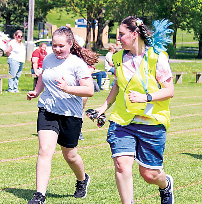 Emma and staff member Molly participate in the 400 metre race.