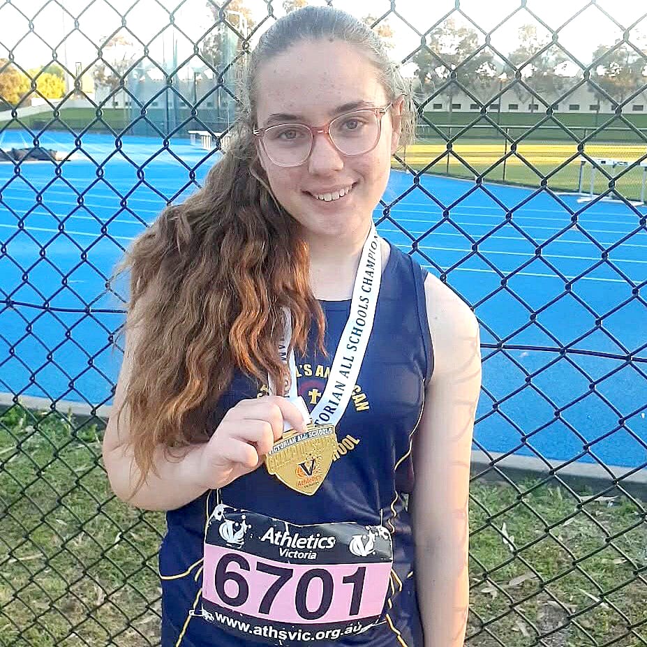 Right: Brooklynn Wyatt shows off her gold medal for the women's under 14 hammer throw at the Victorian All Schools Track and Field Championships.