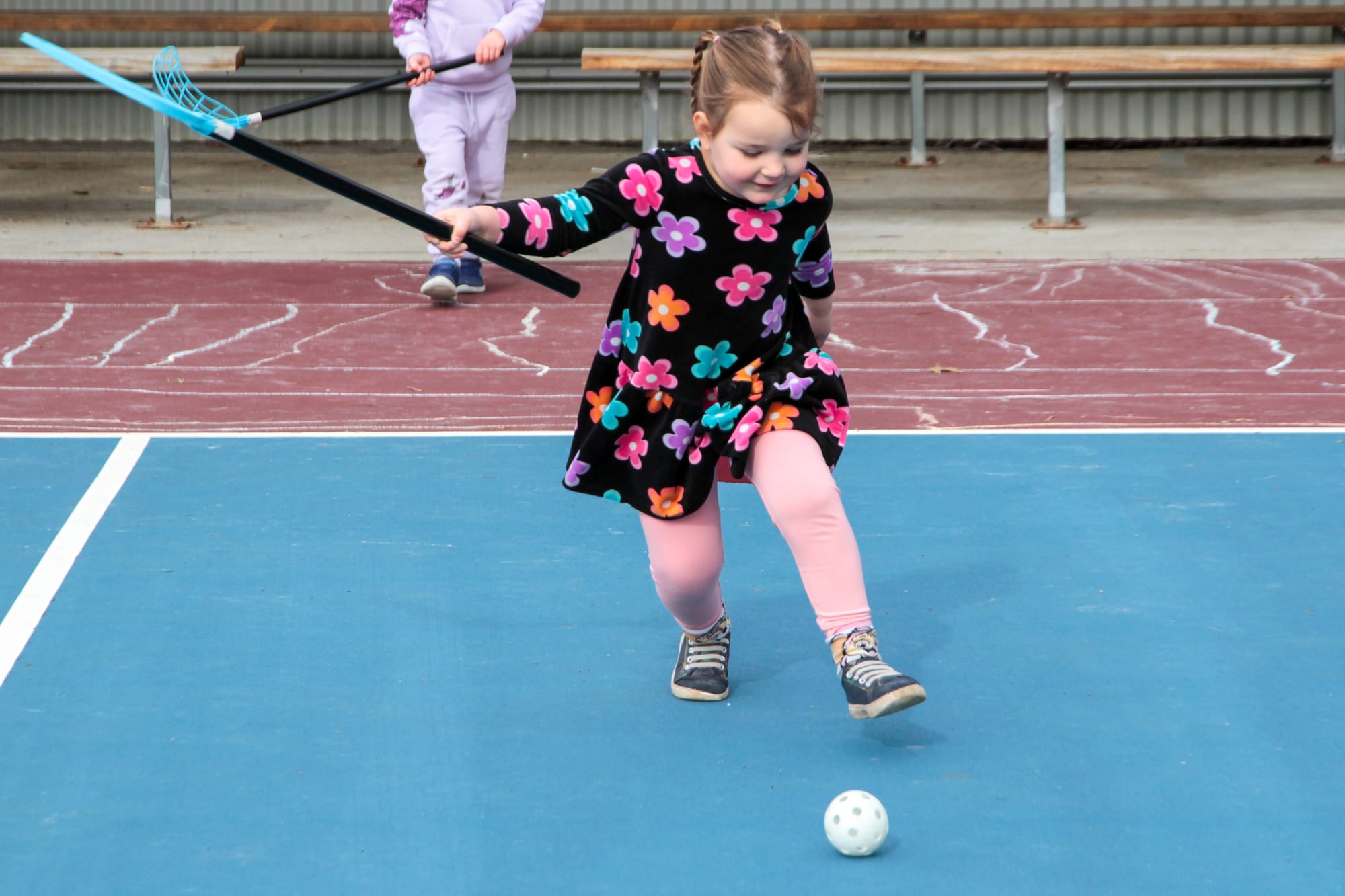 Billie Pearson takes a big swing with the hockey stick.