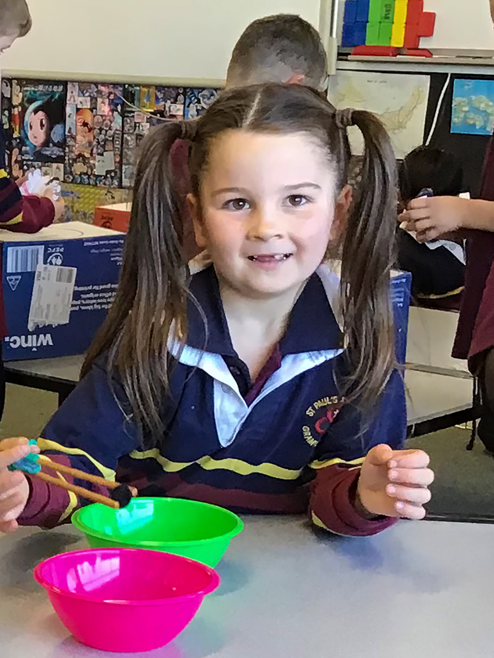 Posie Creighton learning to master the art of chopsticks.