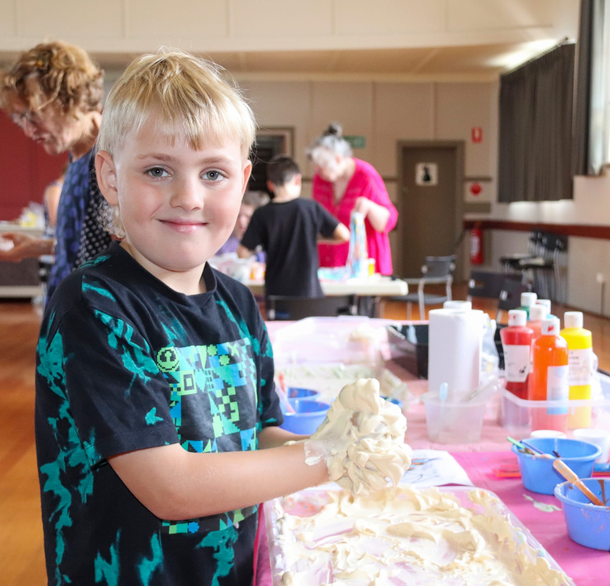Noah Cook enjoys the fun texture of the coloured shaving foam.