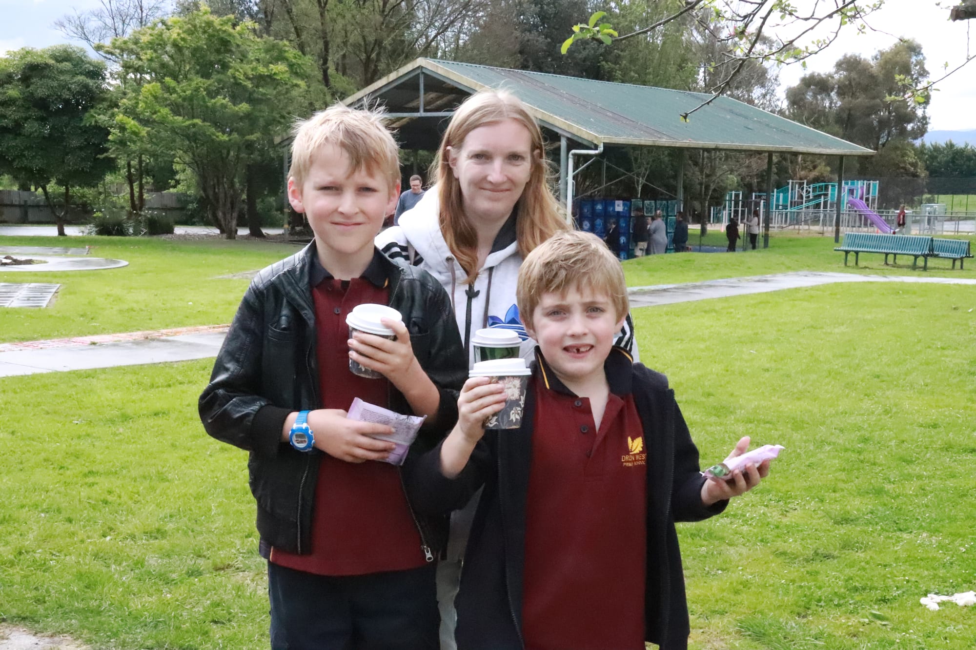 Grabbing a hot drink on a cold afternoon at the Drouin West Primary School art show are (from left) Adrian, Shannan and Lachlan Morrison.