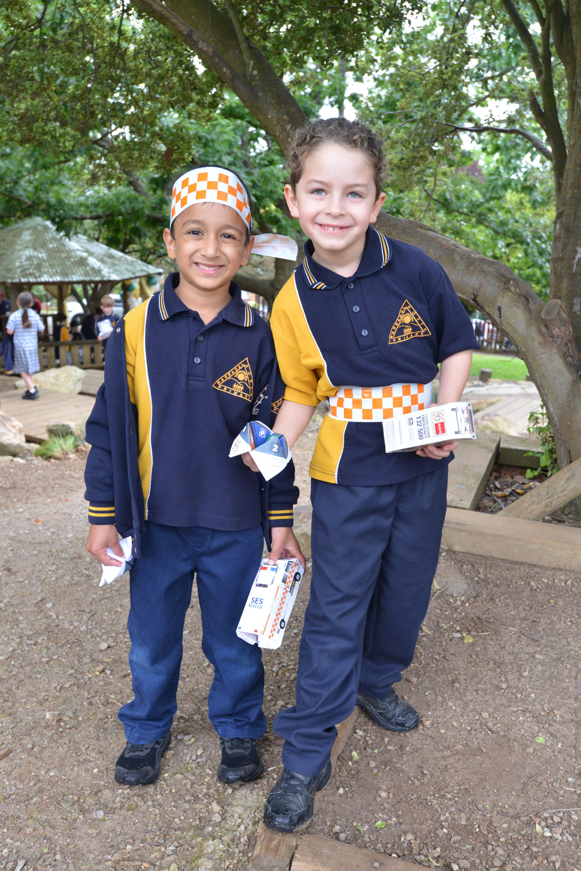 Using SES tape to dress up at the Warragul North Primary School community open morning are Izyaan Zakaria (left) and Joshua Desouza.
