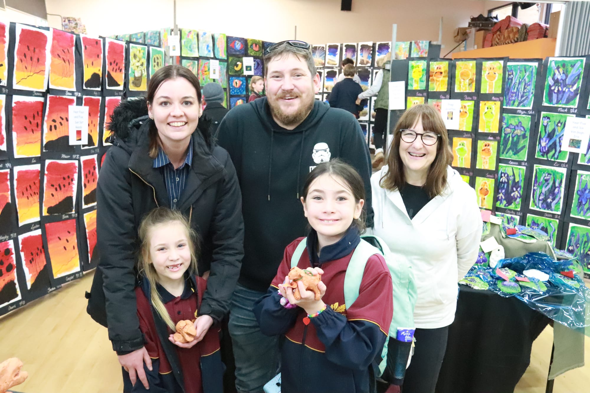 Enjoying the Drouin West Primary School art show and getting a close look at their terracotta animal art are students Aria (left) and Sienna Palmer with parents Simone and Devin and gran Karen Palmer.