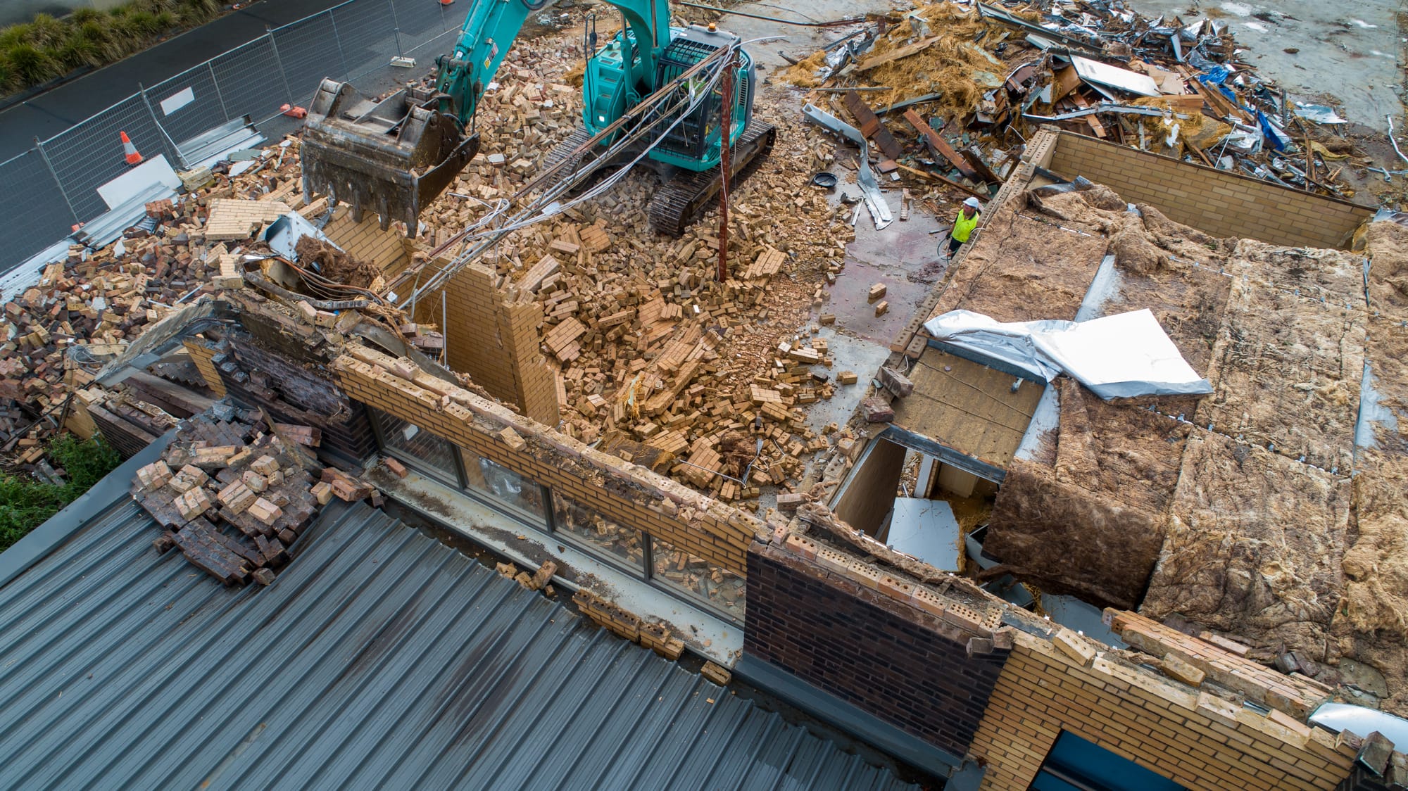 Signalling the end of an era, demolition crews start to pull down the front brickwork of the Warragul Exhibition Hall on Friday morning. The venue of weddings, gala balls and concerts, many Warragul residents have fond memories of time spent within these walls.