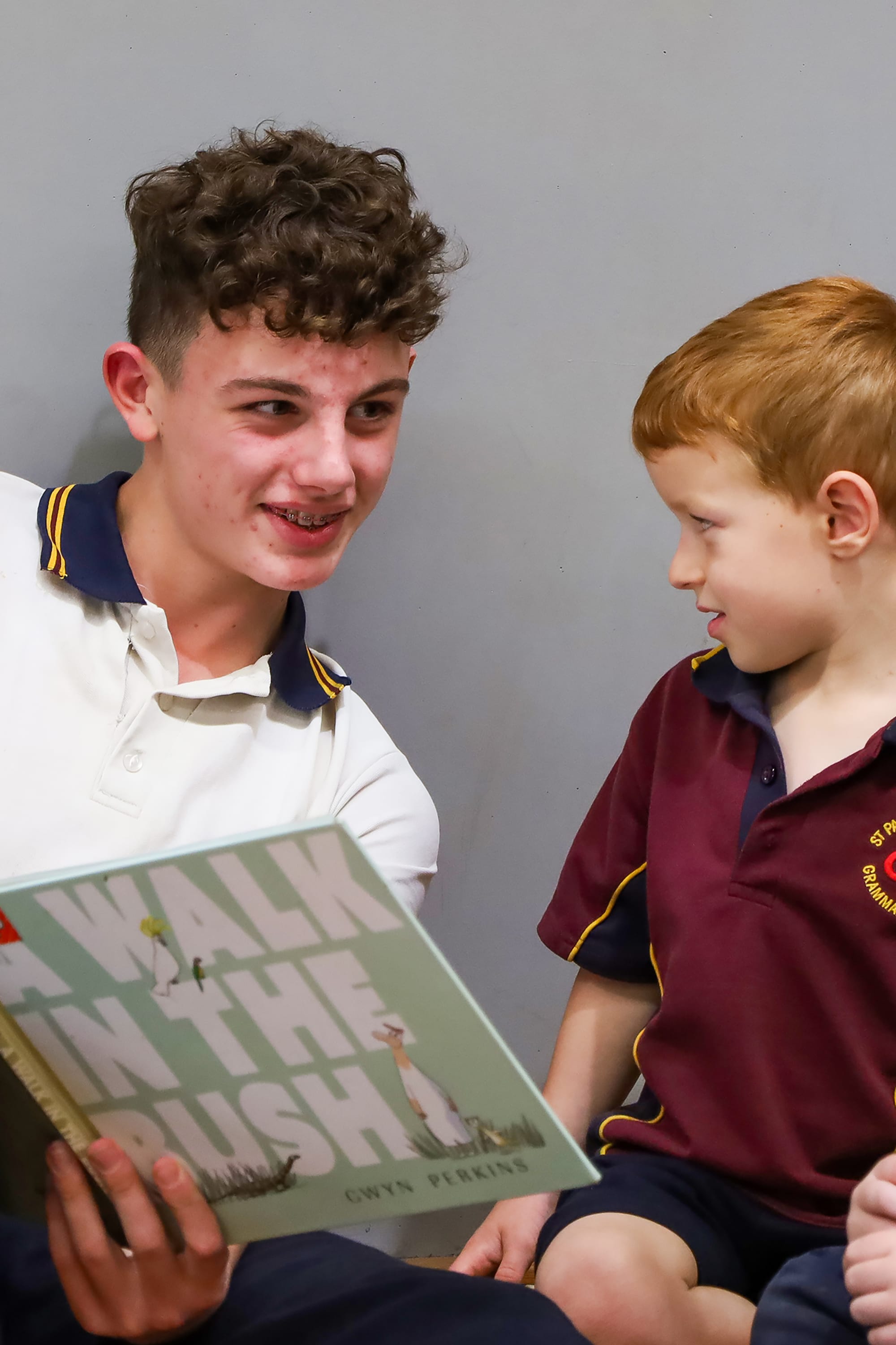 Year 10 student Robbie Arms reads to James Novotny.