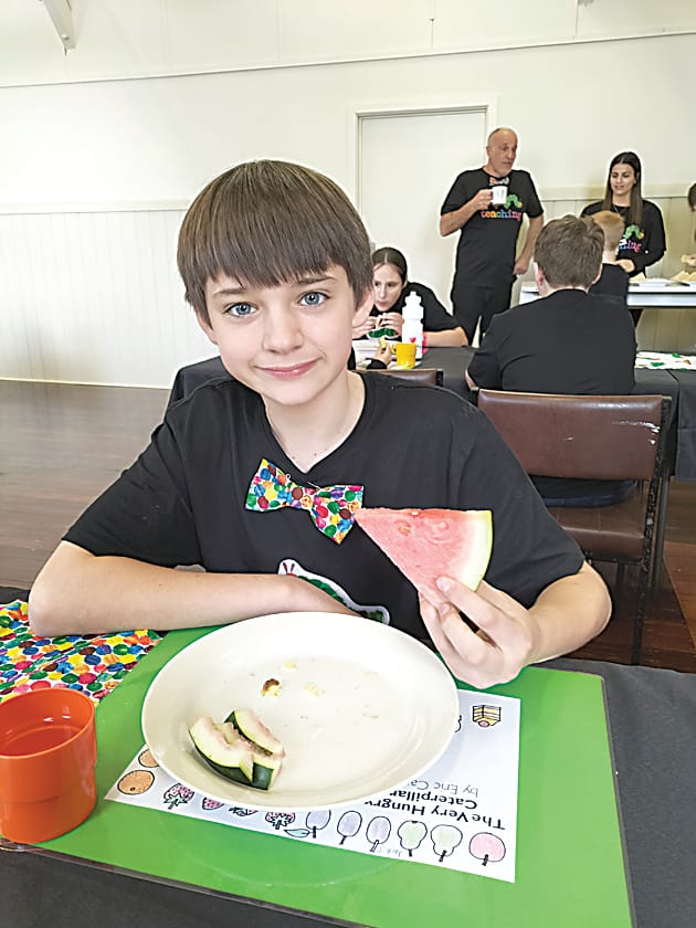 Digging into some watermelon is Jack Olsson.
