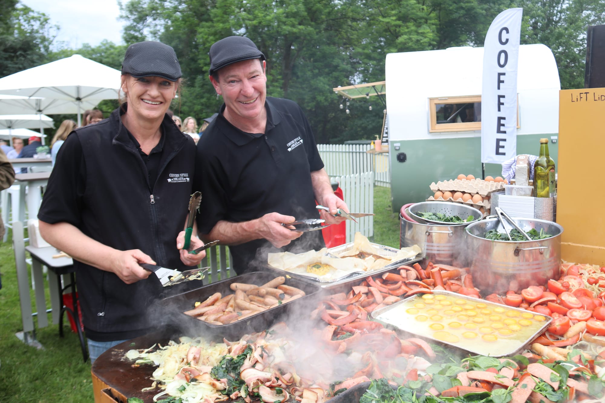 Garfield Country Style Meats owner John Preston (right) is helped by staff member Annalise Tumbas to put together a smorgasboard of brunch delights at the Warragul Farmers Market Grazing Brunch on Saturday morning.