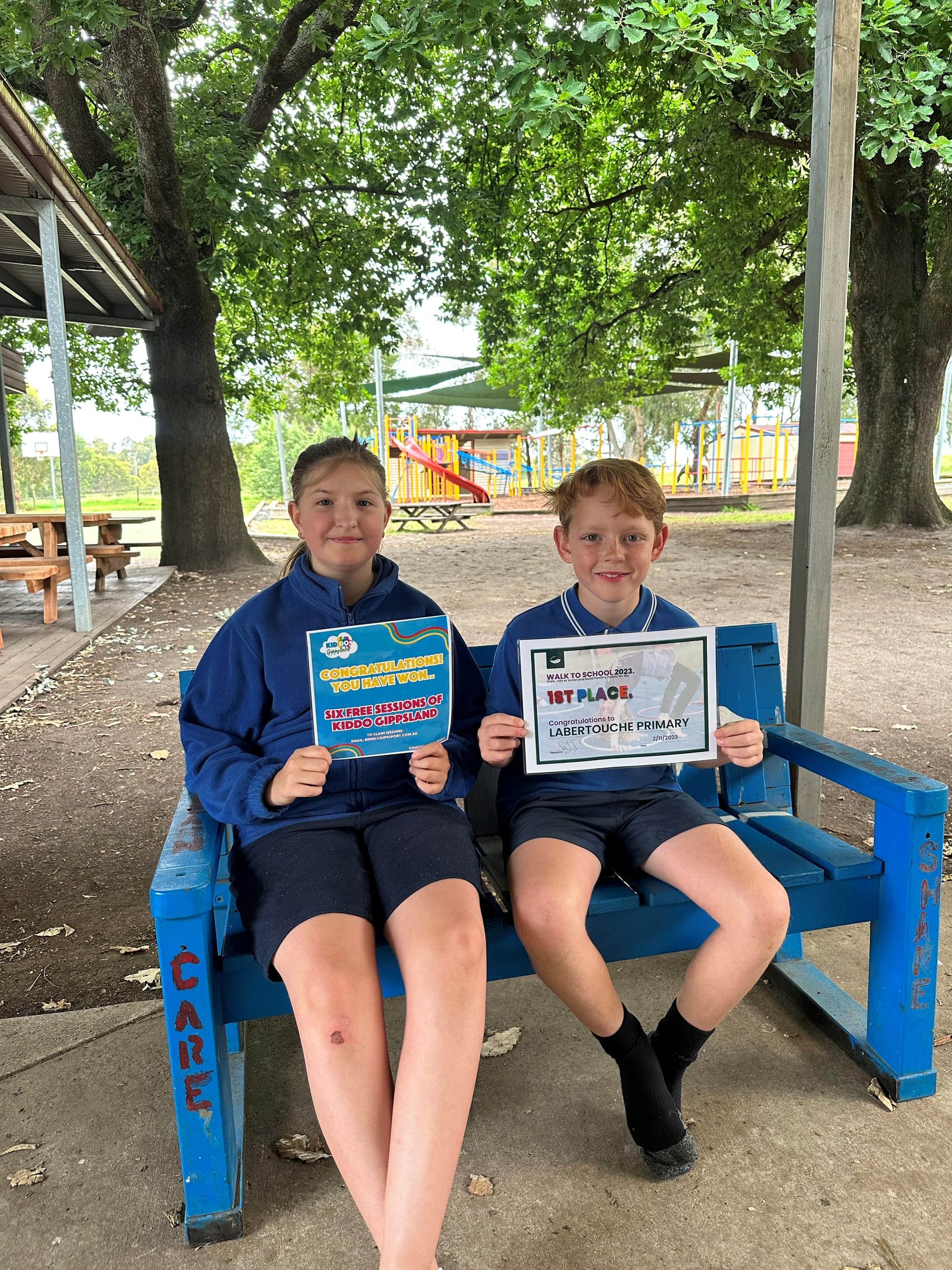 Labertouche Primary School students Tahlia Brown and Hudson Heath celebrate their school taking out first prize in the Baw Baw Shire's Walk to School Week competition.
