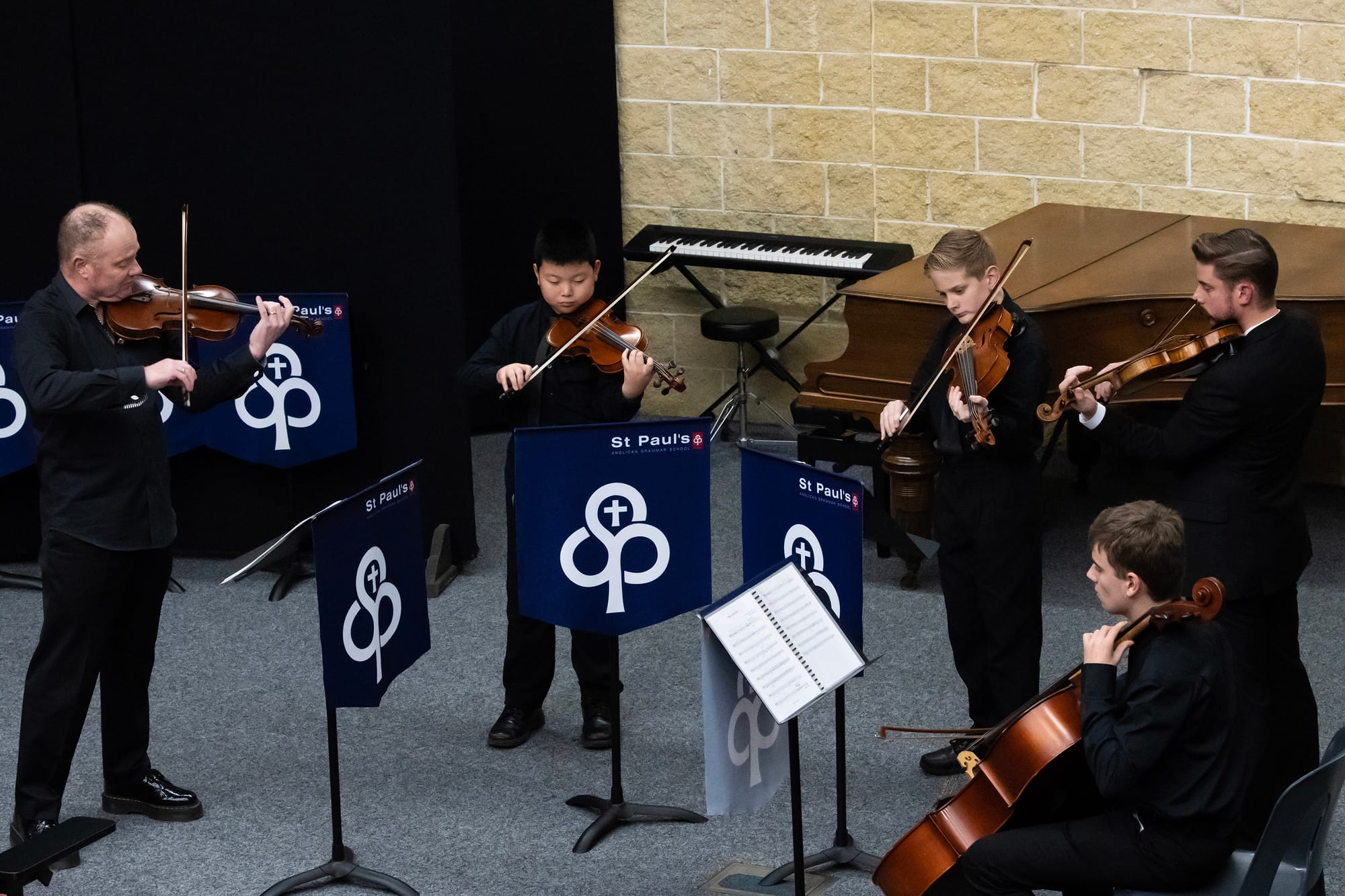 Guest musician Mr John Noble performs with Anderson Qian, Kynan Petrie, head of St Pauls Academy of Music Mr Ben Sim and Max OConnor.