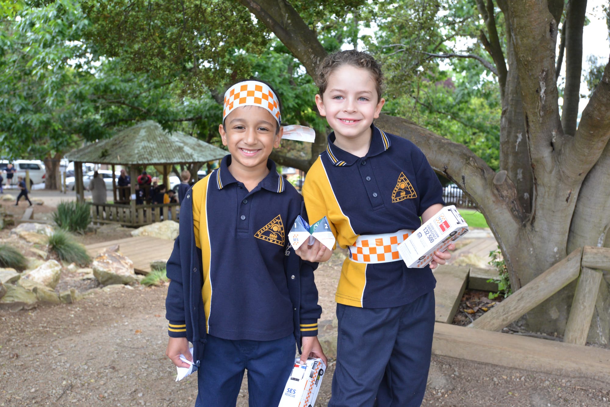 Using SES tape to dress up at the Warragul North Primary School community open morning are Izyaan Zakaria (left) and Joshua Desouza.