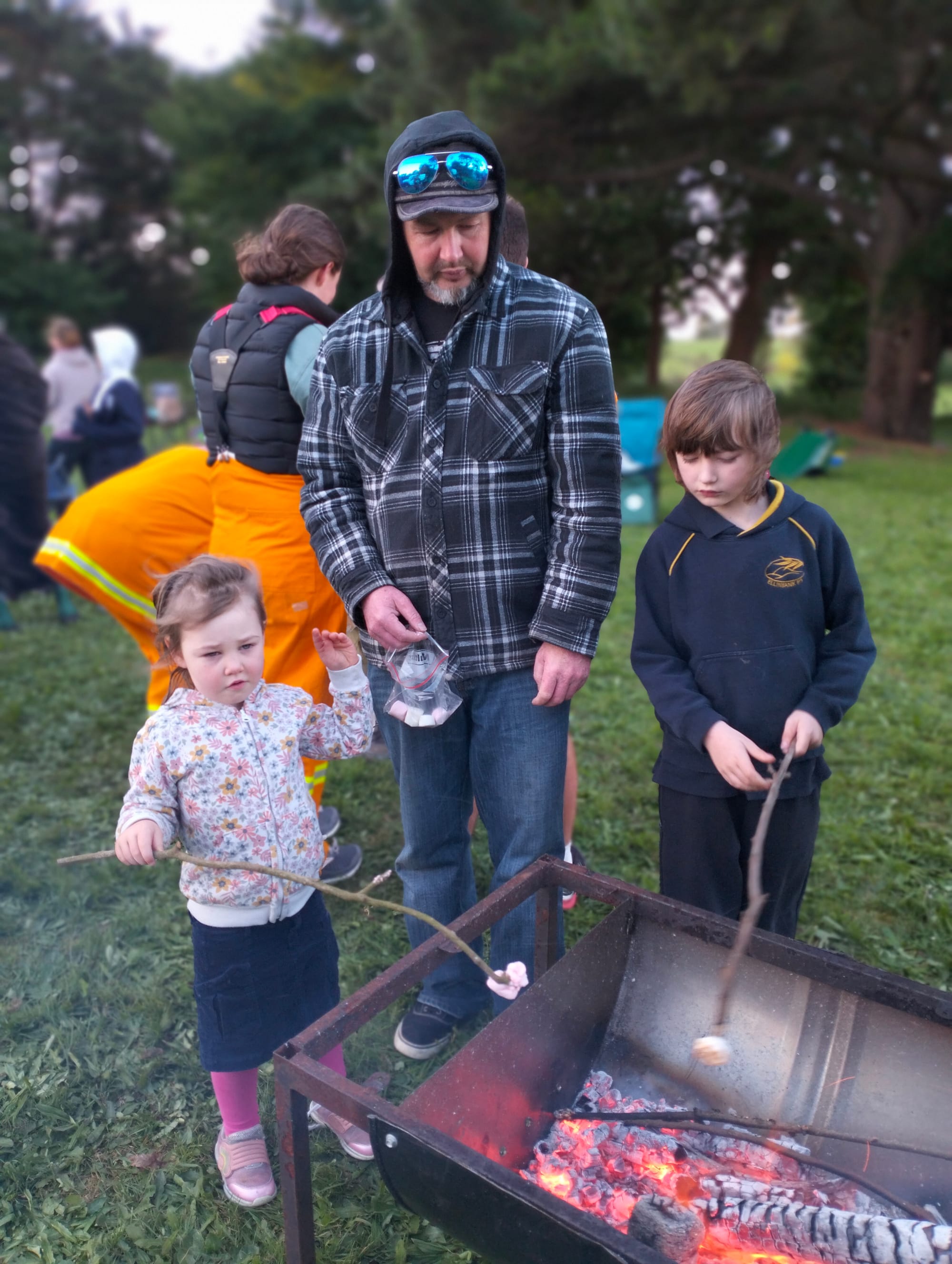 Faith, Tex and Max Foley roast some marshmallows.
