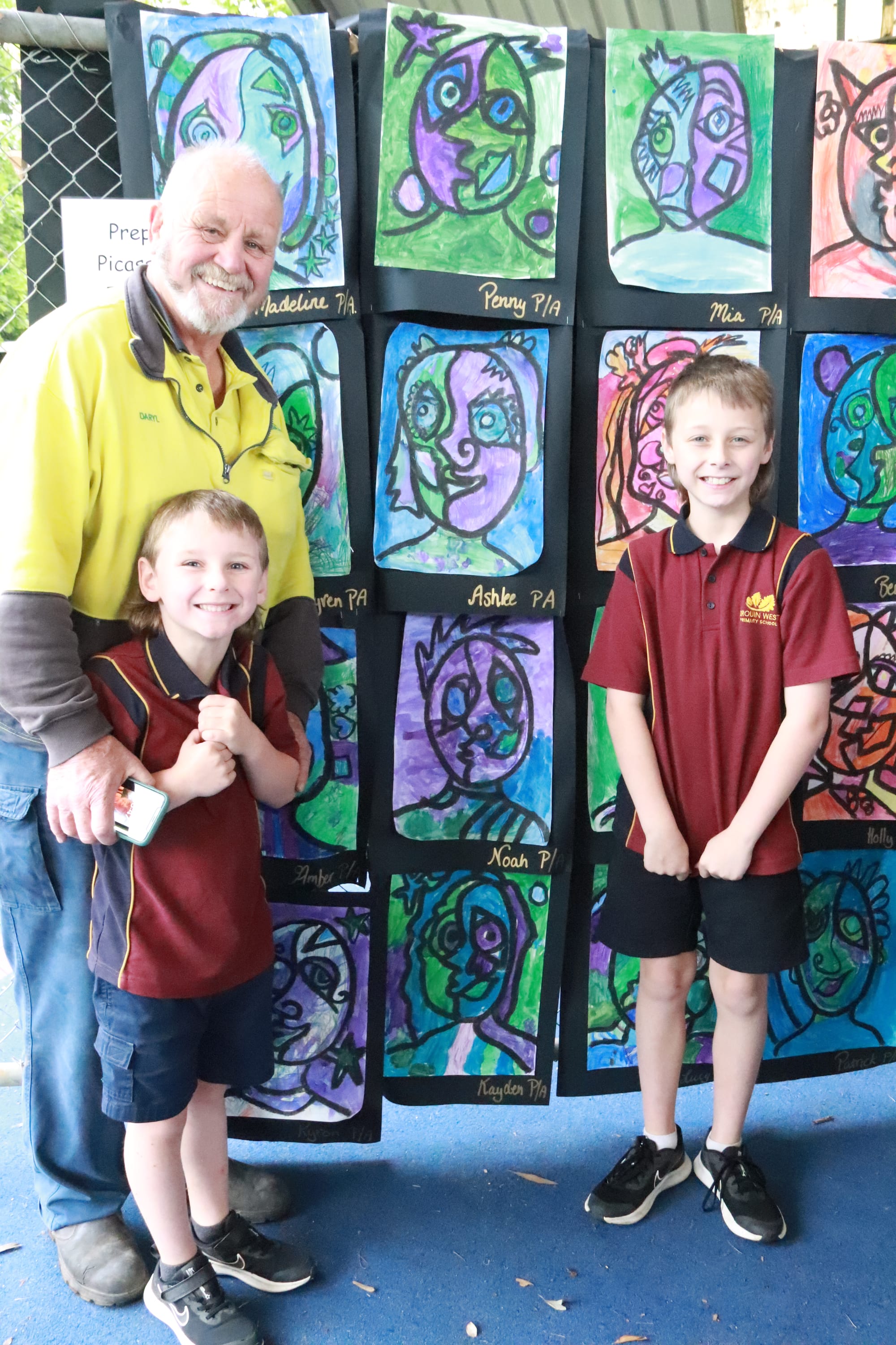 Showing their pa Daryl Steet the wall of Picasso inspired art at Drouin West Primary School's art show are Kayden (left) and Lynken Steet.
