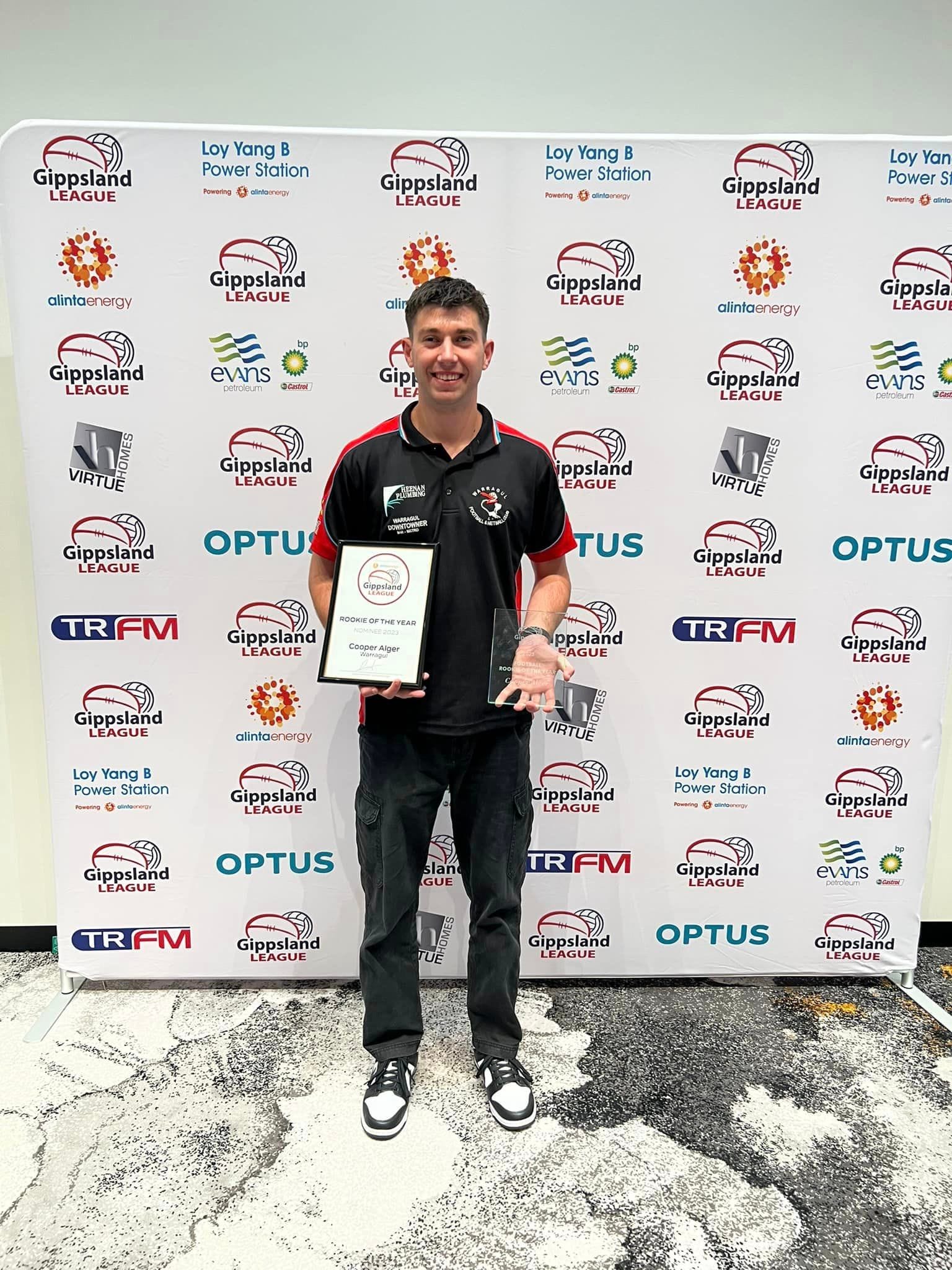 Cooper with his Rookie of the Year and Team of the Year awards at the Gippsland League's presentation night. 