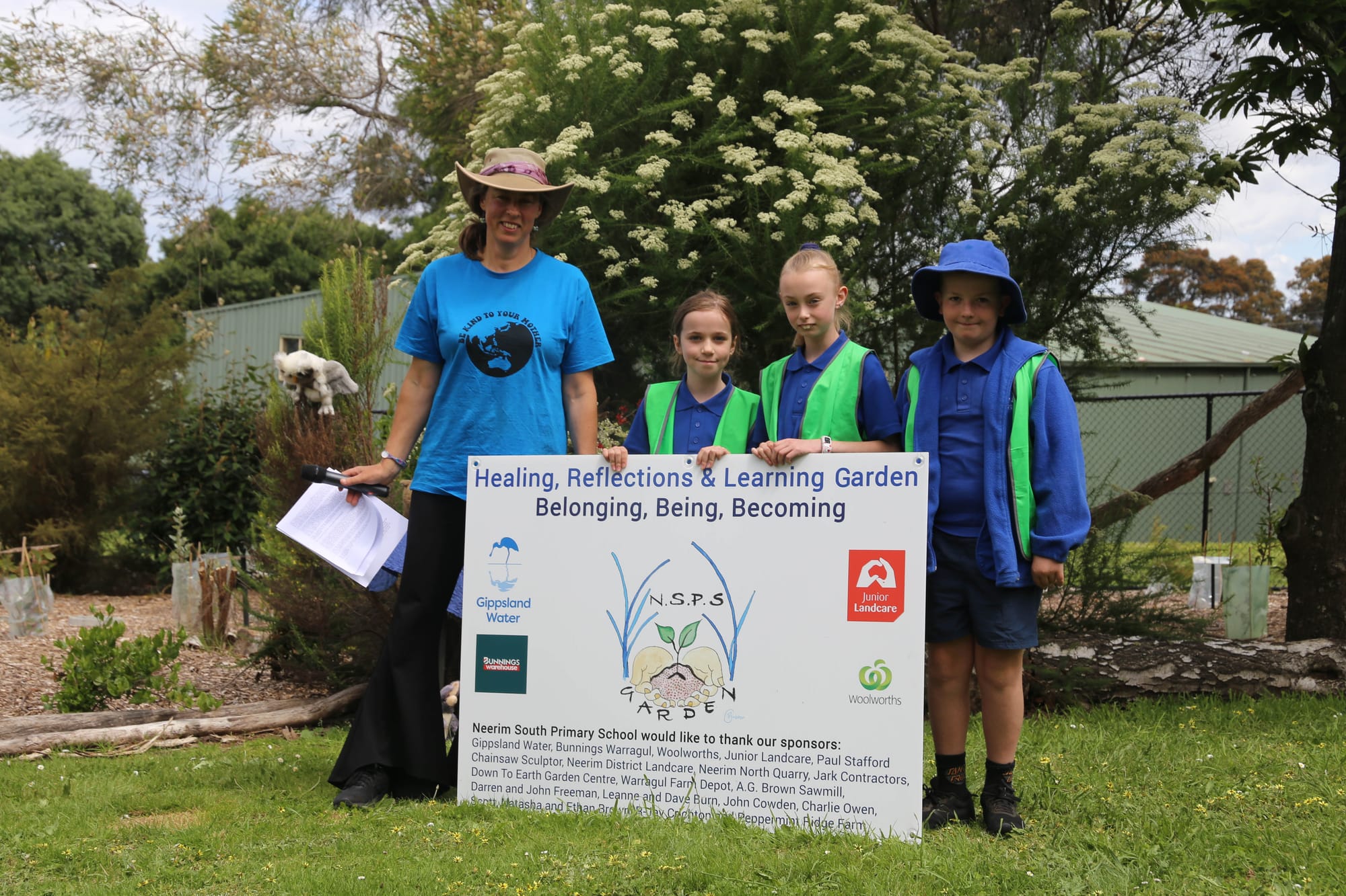 Teacher Natasha Brown, Emma Bransgrove, Zoe Lamb and Spencer Banks celebrate the opening of the habitat garden.