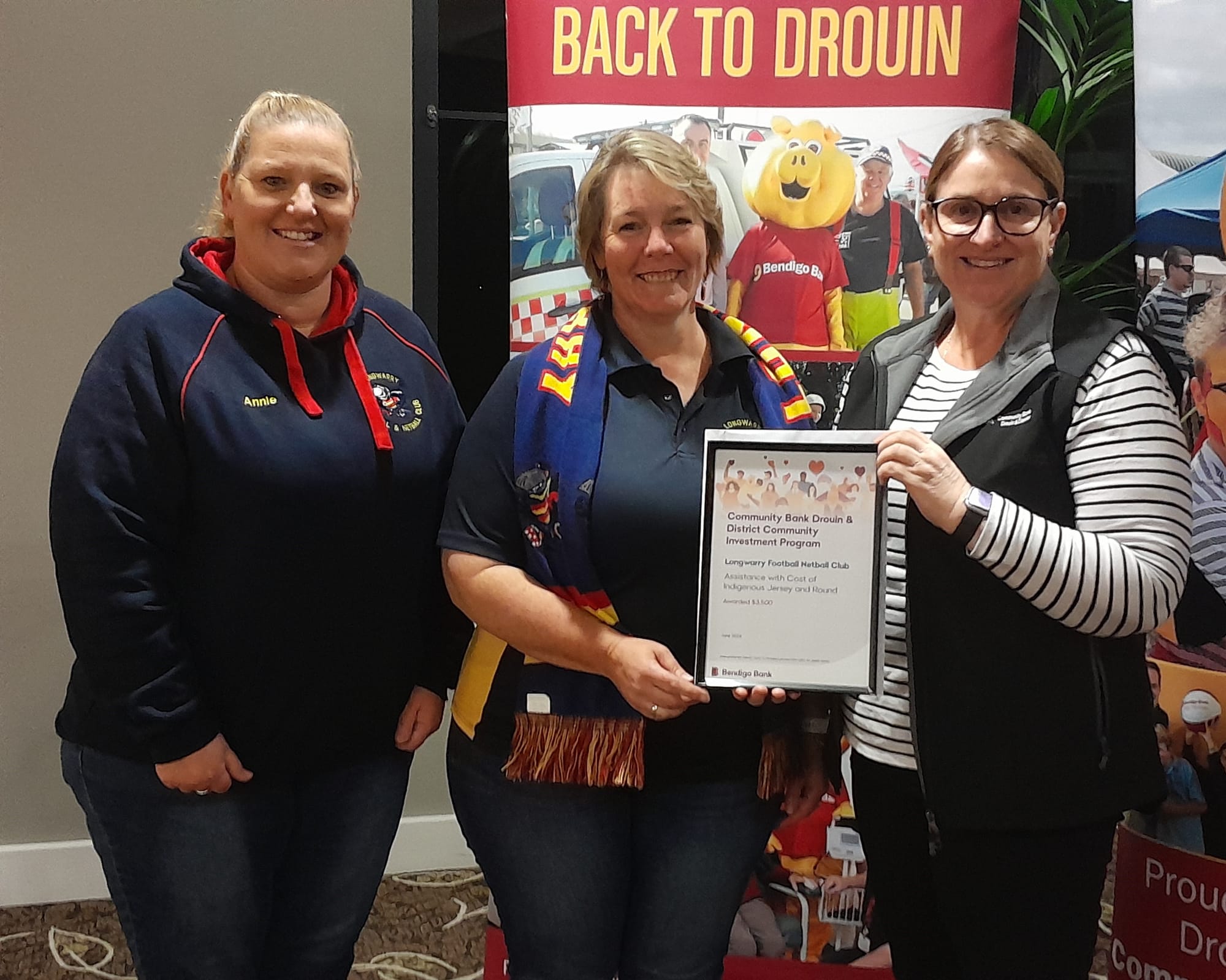 Longwarry Football Netball Club's Anne van der Heyden and Narelle McInnes with bank director Vanessa Marsh.