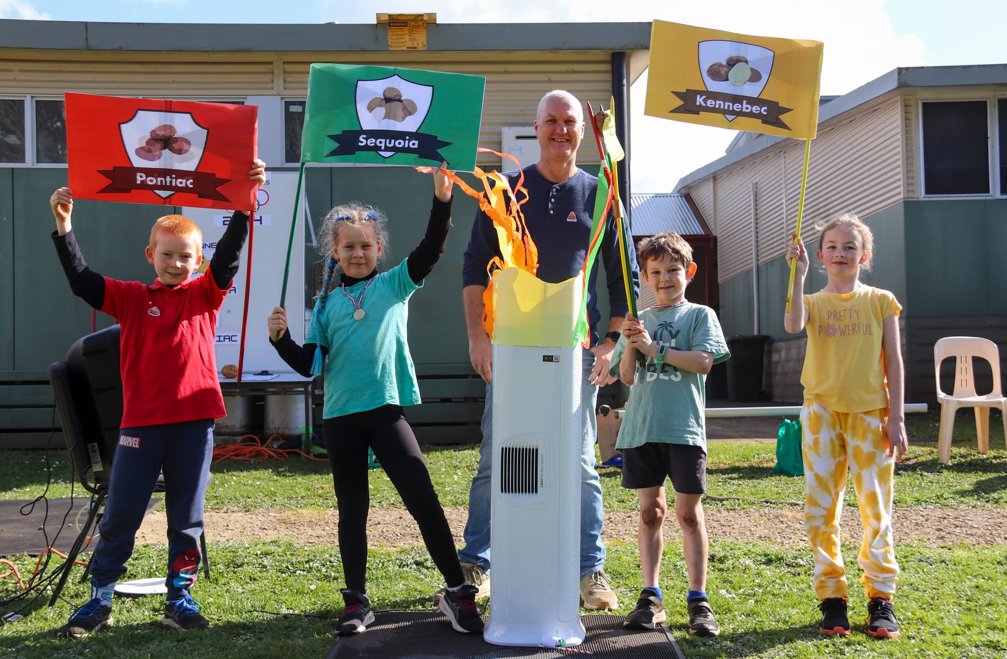 Posing with the homemade Olympic flame are torch carriers (from left) Tadgh Hillbrick, Evie Mara, principal David Shields, Jack Parker and Jordan Westbury.