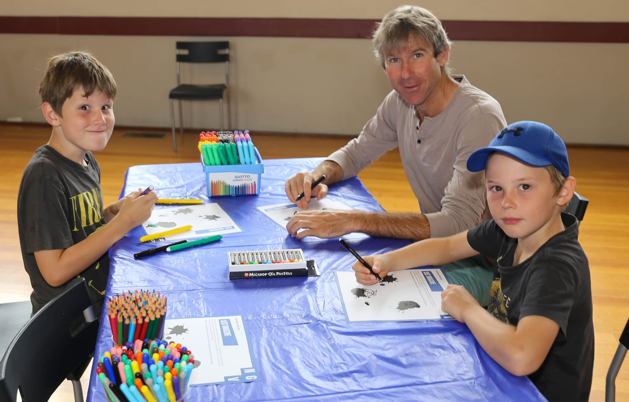 Uncle Lochy Downey from Neerim East, creates pictures with Spencer and George McAuley from Bunyip.