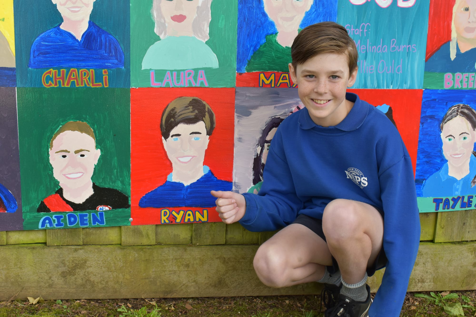 Ryan Peterson is all smiles showing off his portrait.