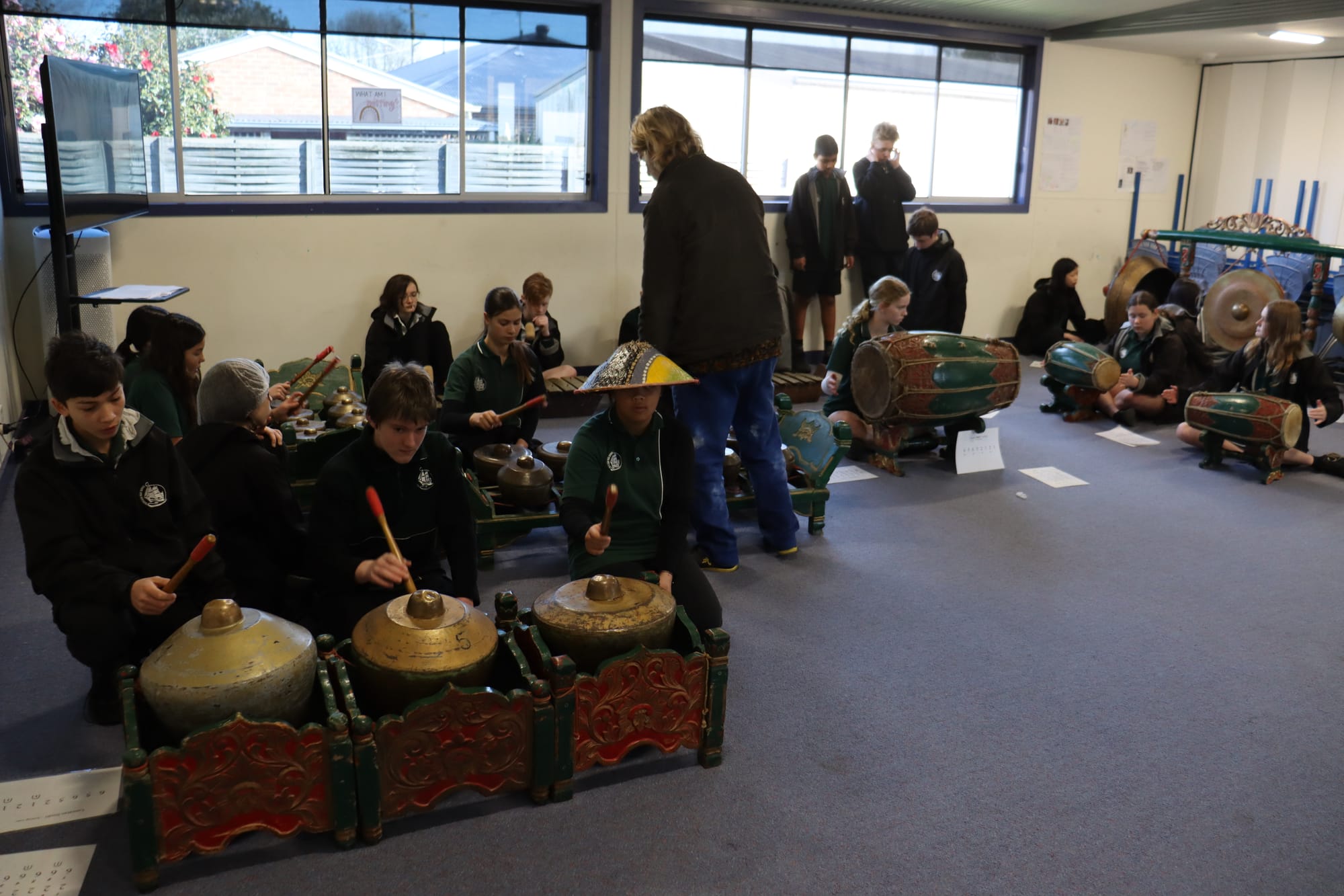 Students learning to play traditional Indonesian instruments take part in a symphony