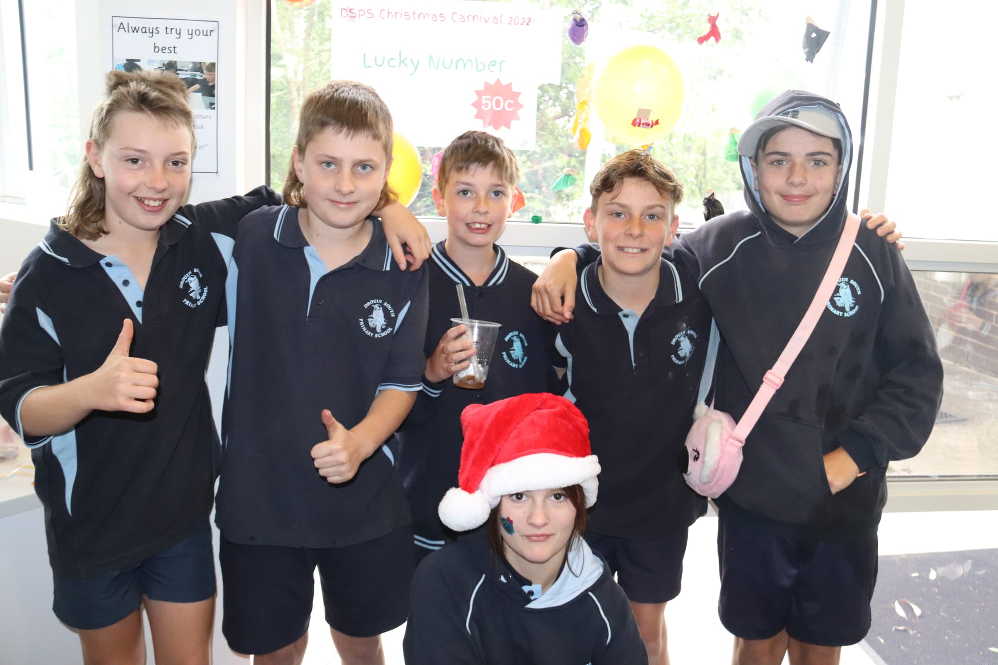 Showing off the balloon popping stall are Jack, Cody, Tyler, Taj, Ethan and Eden (front).
