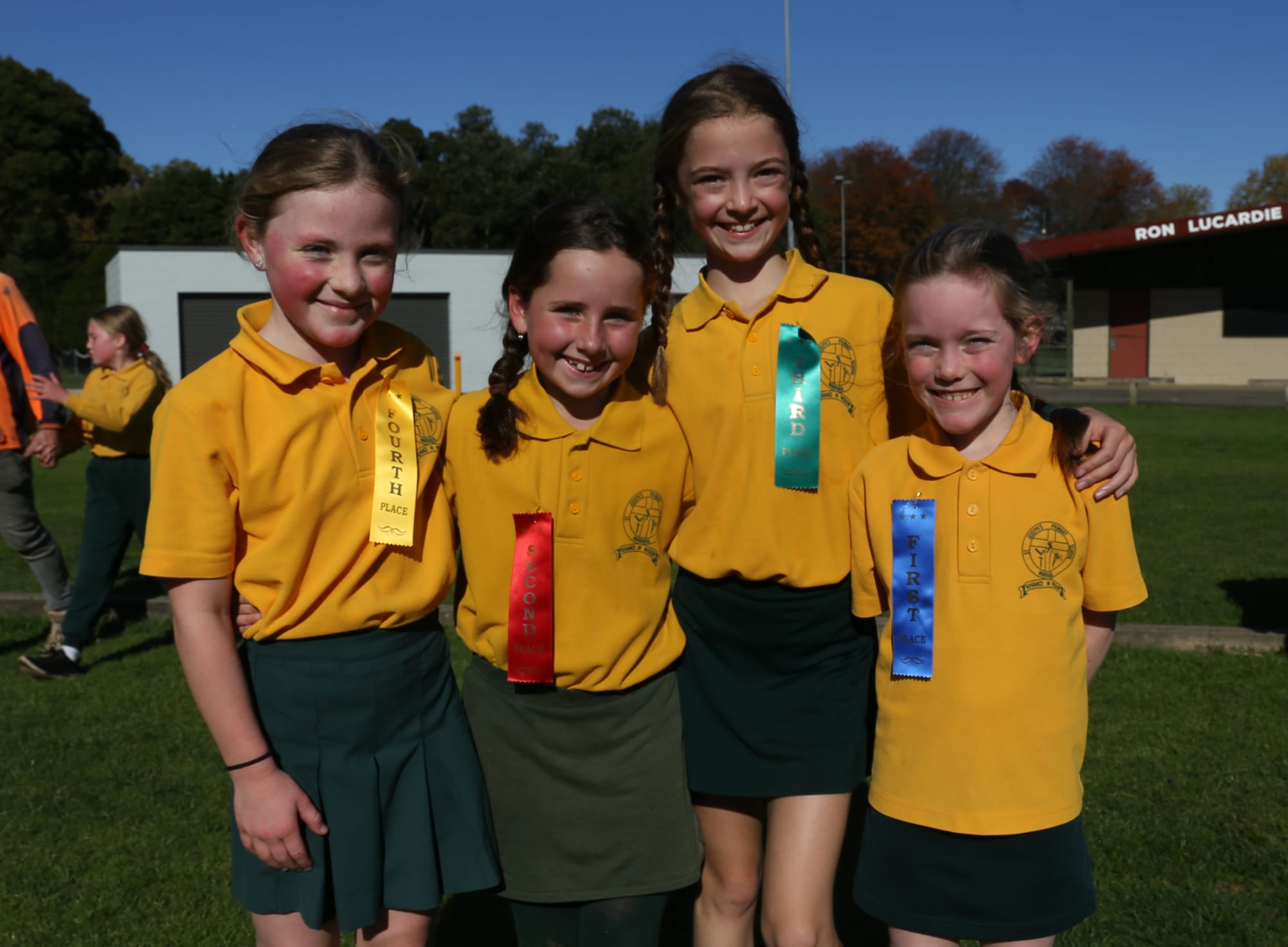 Proudly wearing their ribbons after running in the St Joseph's Primary School cross country race for eight to 10-year-olds are (from left) Sophie, Alirah, Lexi annd Sinead.