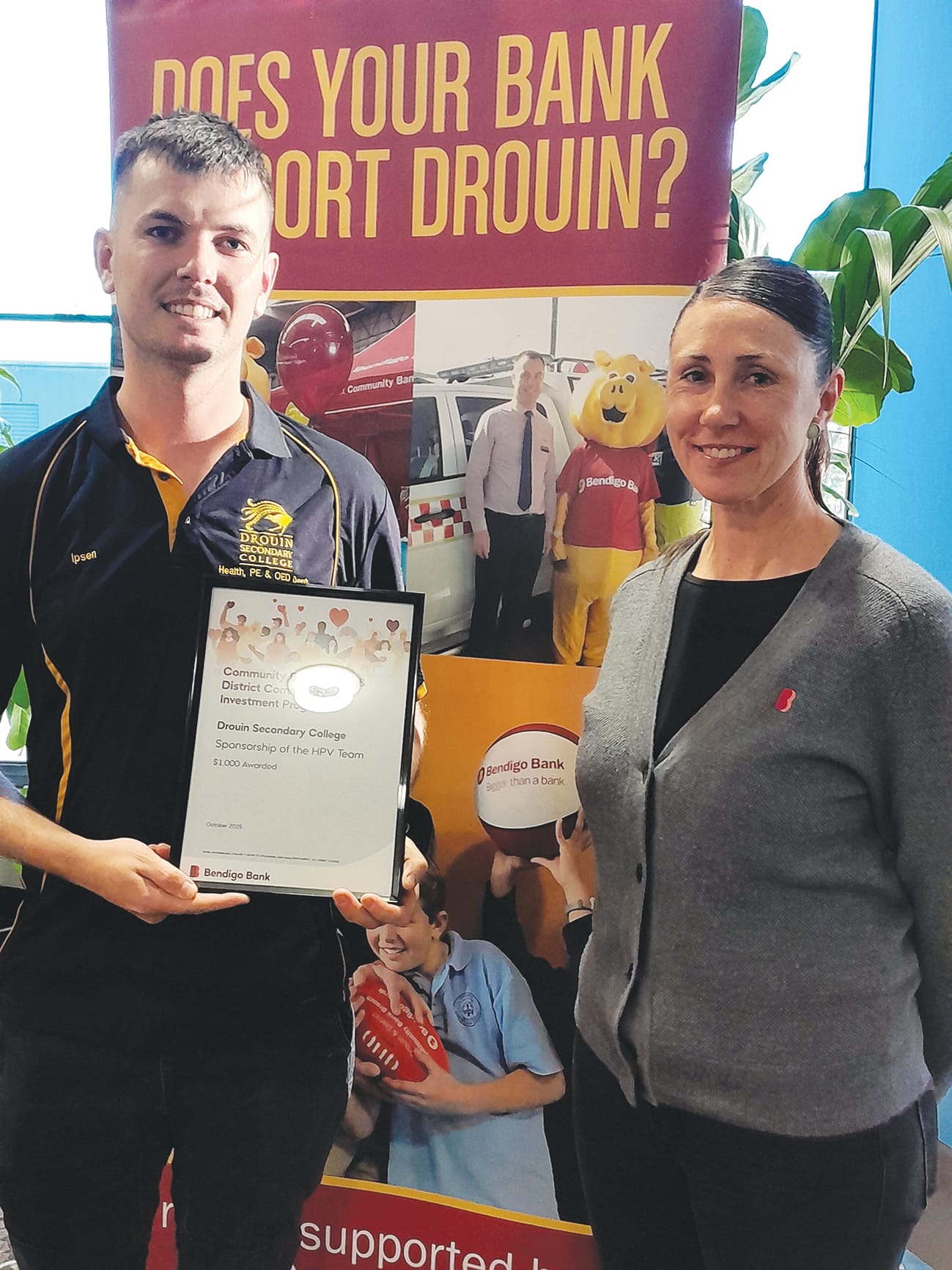 Evan Ipsen receives sponsorship for the Drouin Secondary College human powered vehicle program from customer service officer Jade Dance.