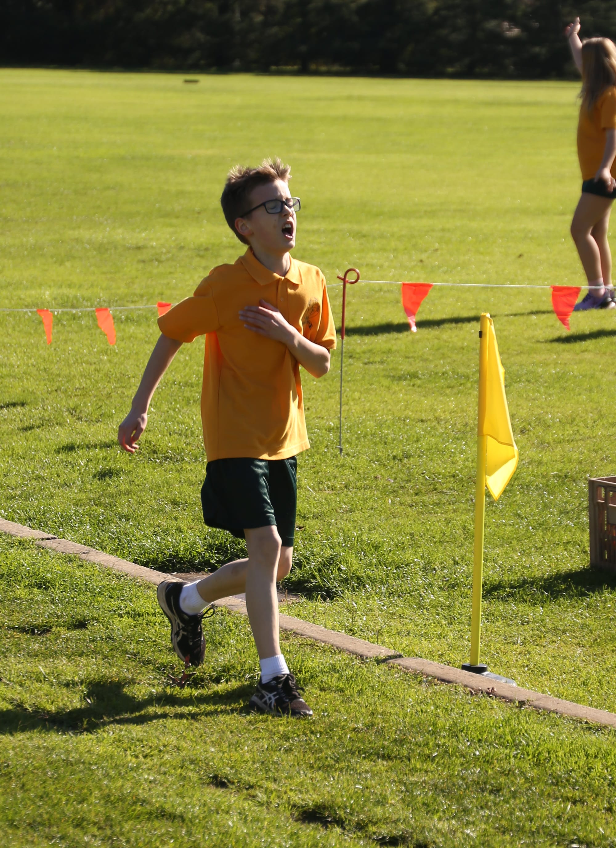William shows relief and exhaustion upon crossing the line at the St Joseph's Primary School cross country.