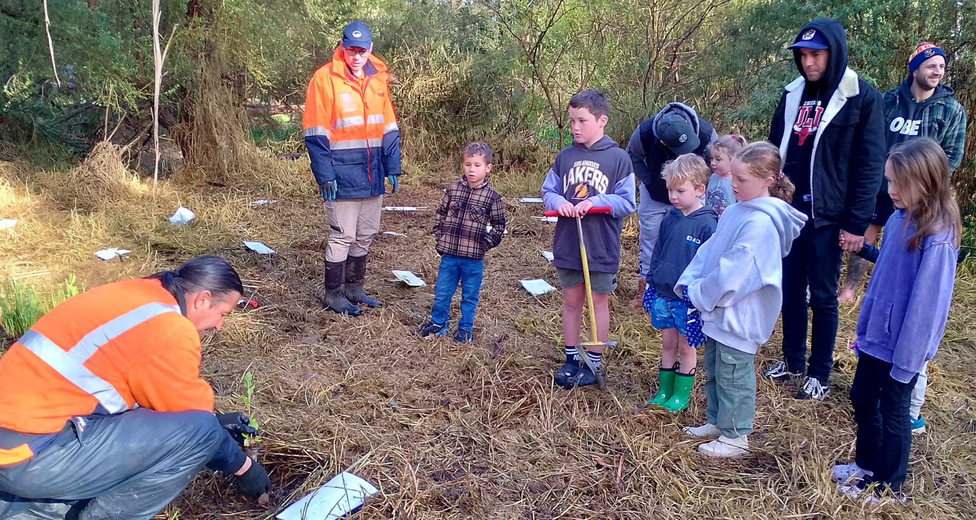 Baw Baw Shire staff Nick Jones (left) and Tyson Dennis give planting instructions to volunteers from Longwarry Football Club (from left) Reggie Cuckson, Oliver Granger, Kobe McHugh, Sienna Holland, Milla Granger, Ben Cuckson, Anthony Salce and Rylee McHugh.