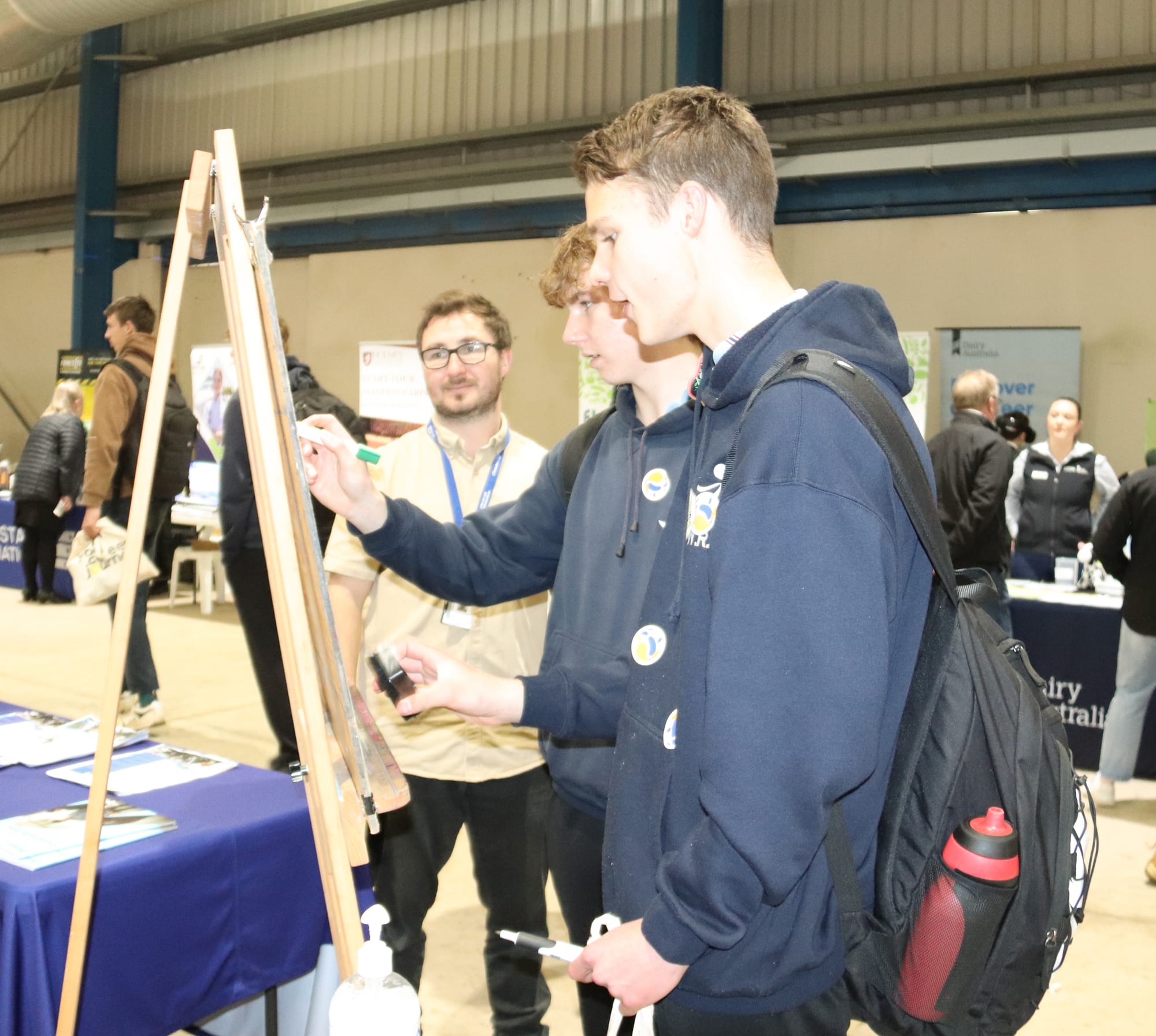 Warragul Regional College Year 9  students Thomas Lilford and Artie Davidson pay close attention to the Chisholm Institute activity run by James Sainsbury