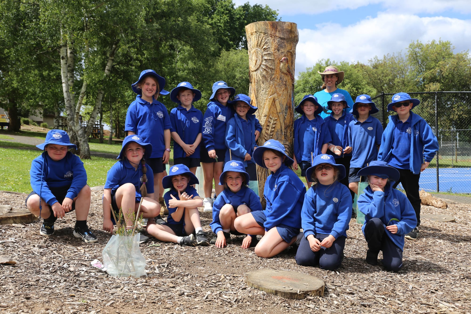 Grade 1/2 students in the garden. Back row: Summer Russell, Zac Parker, Ahri Dunn, Alex Tinsley, teacher Natasha Brown, Hudson Heath, Alex Brown, Jacob Naus, Nash Ellis. Front row: Peyton Pfeiffer, Navia Tomasetti, Noah Keft, Audrey Bransgrove, Matilda Bottom, Tikayah-Rose Turner and Alanah Freeman.