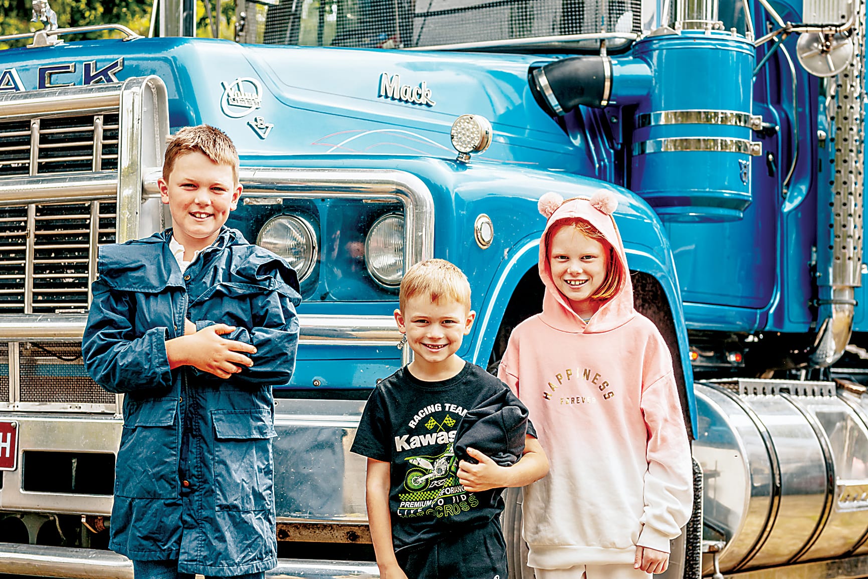 Drouin South's Dylan, Travis and Evie Marshall check out some trucks.