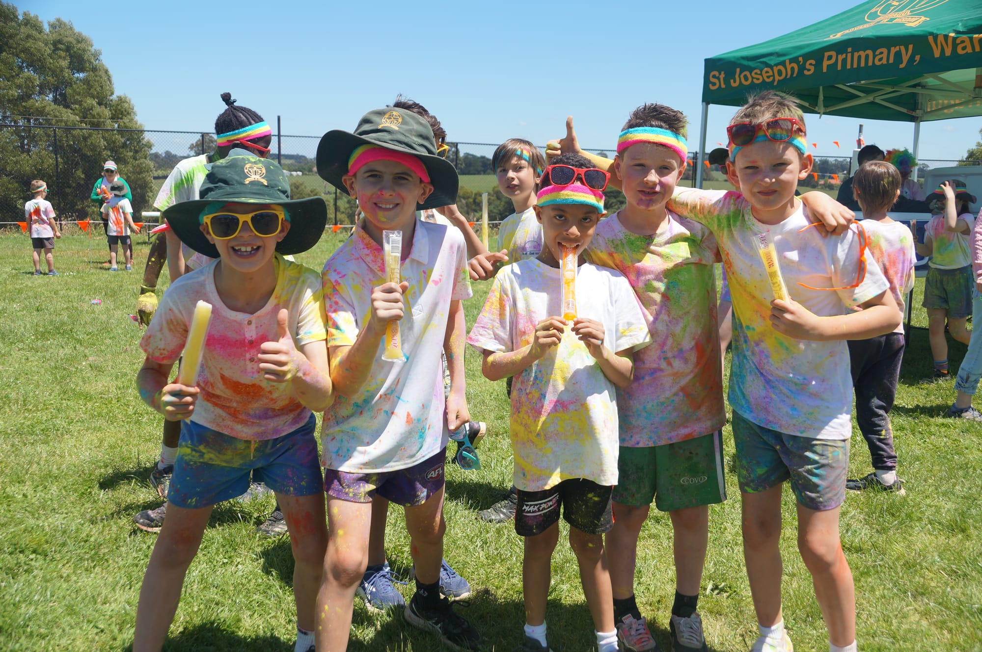 Celebrating the end of their colour run with an icy pole treat at St Joseph's, Warragul are (from left) Zac, Josh, Emeka, Xander and Lucas.