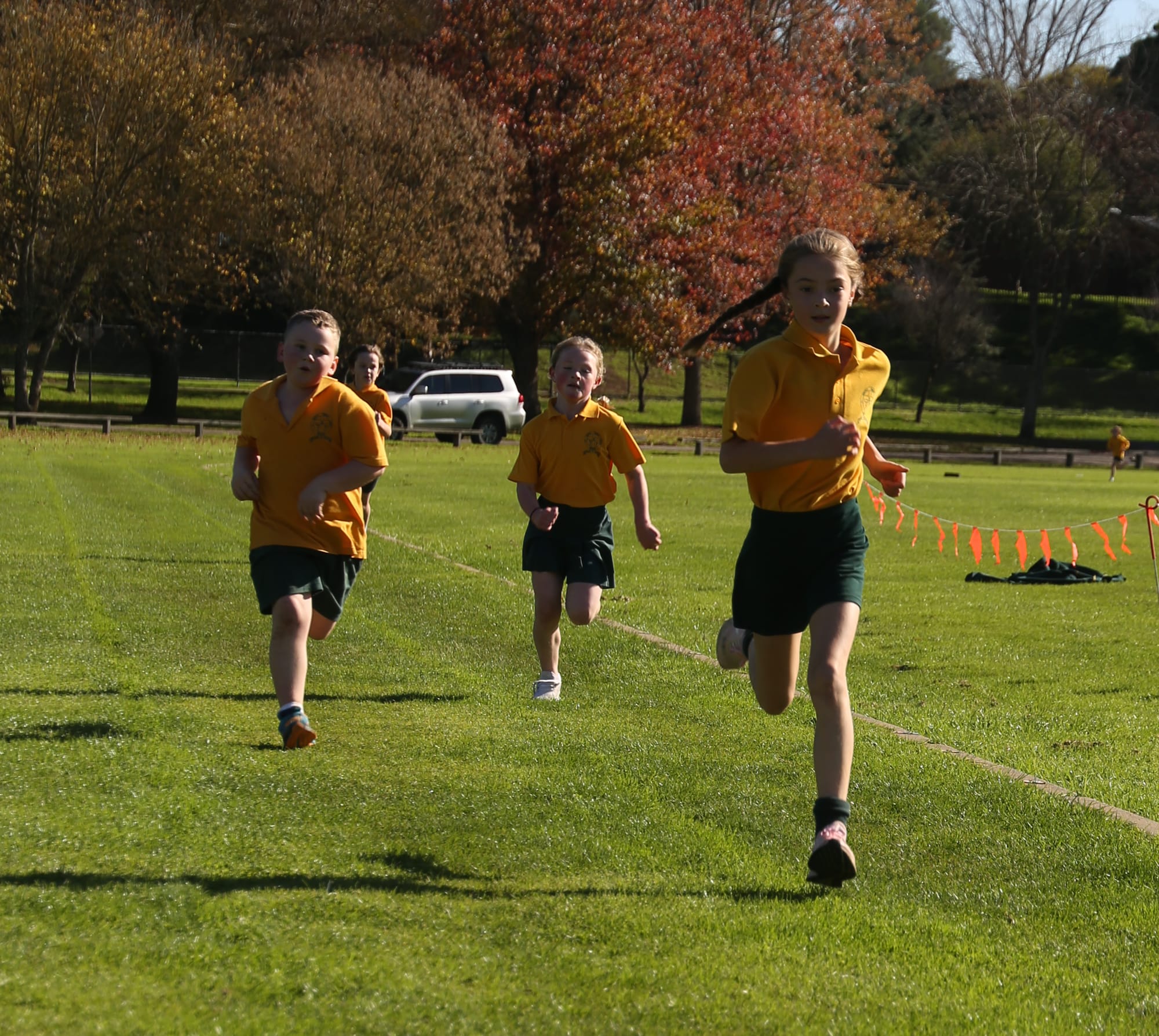 Sprinting towards the cross country finish line are (from left) Riley, Sophie and Lexi.