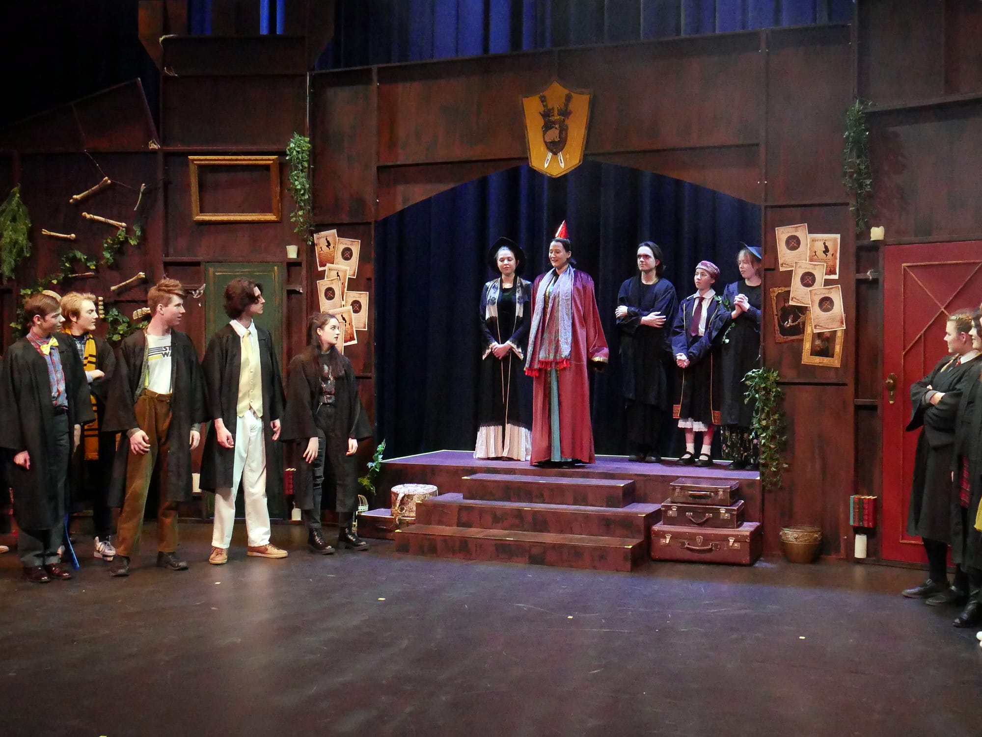 St Pauls students in a scene where the Puffs are waiting anxiously, hoping they dont come last again while the headmaster announces the winner of the house cup at the end of year one.