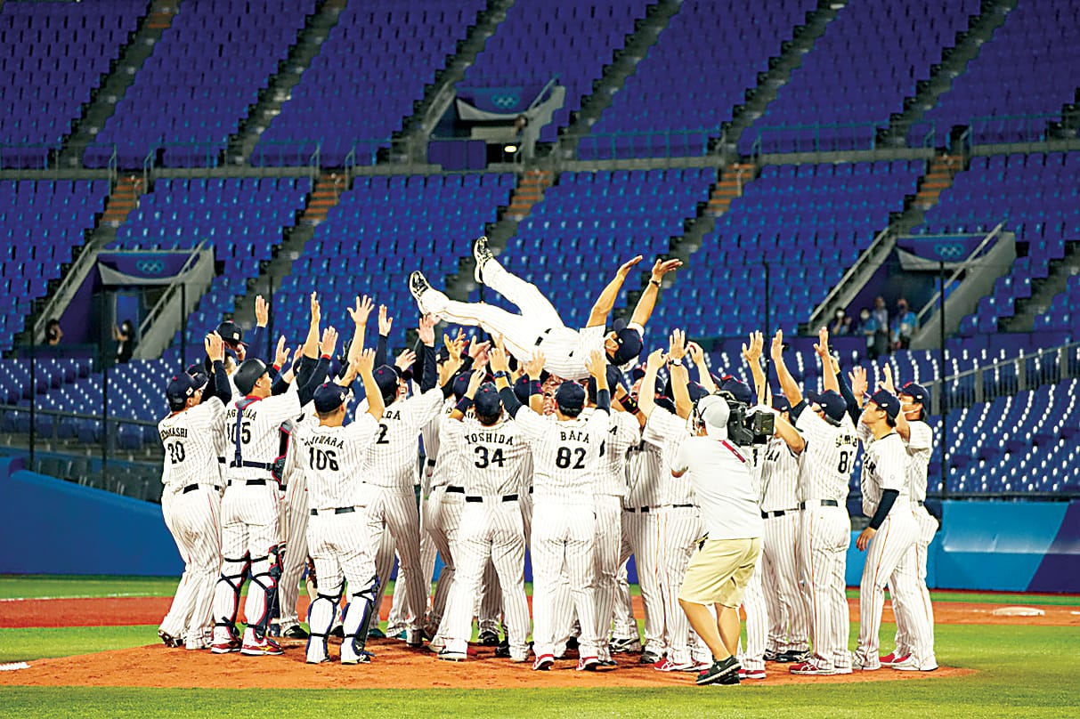 The Japanese Olympic baseball team celebrating their win in an empty stadium.
