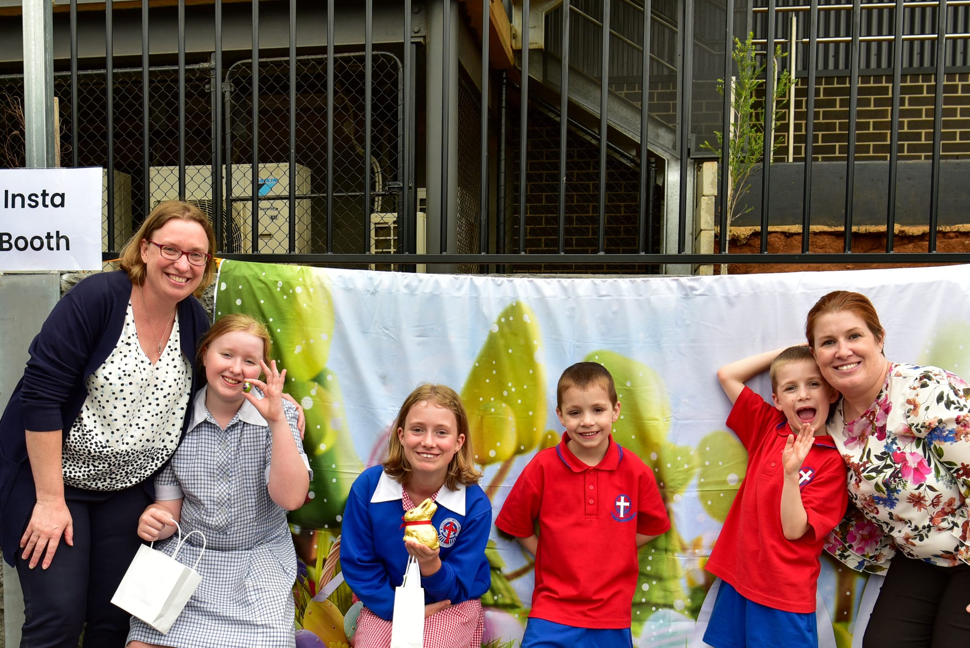 Sarah and Alanna Lucas, and Mischa, Leroy, Malachai and Sarah Crimmins enjoy the Insta booth at the St Paul's Warragul campus community Easter egg hunt.