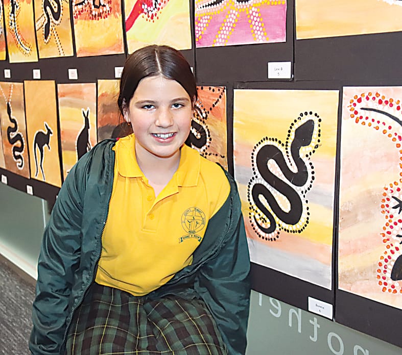 Grade six student Bonnie showed off her Indigenous dot painting of a snake. Bonnie said the dots represented connection to the land and Dreamtime stories.