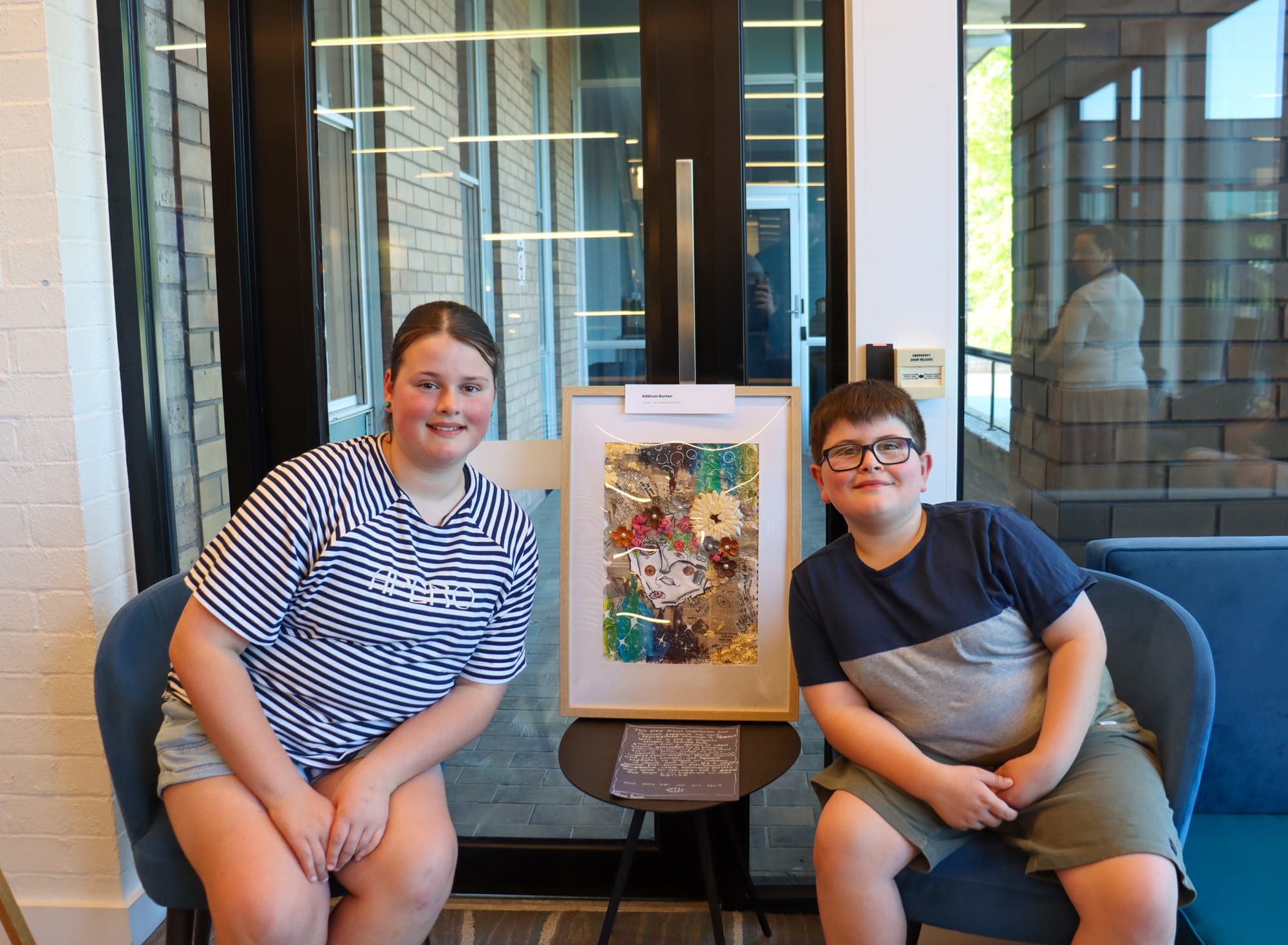 Addison and Austin Burton admire the artwork Addison created for the theme 