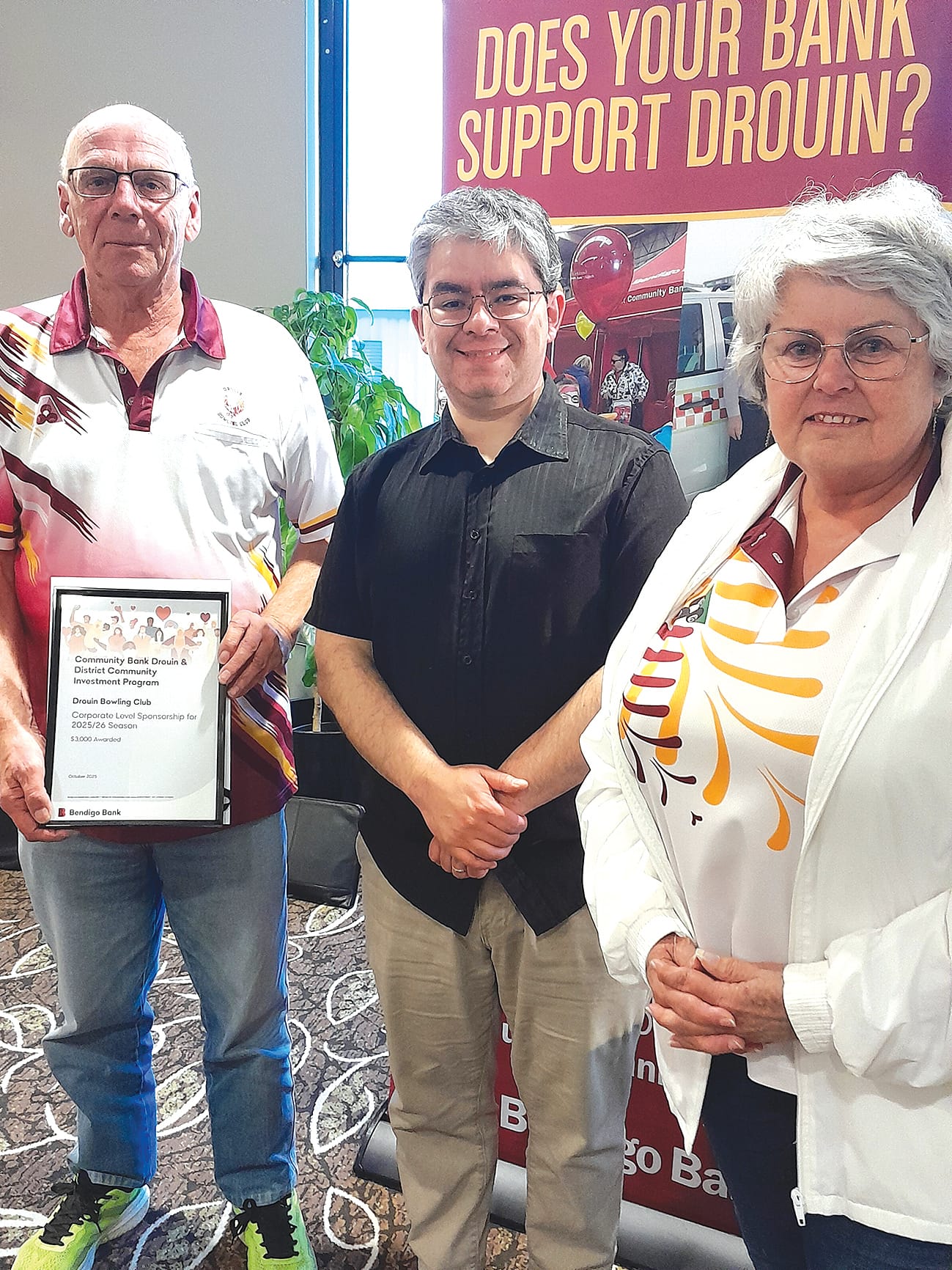 Drouin Bowls Club's Rudy Kerkvliet and Helen Kerkvliet with bank director Rob Celada.