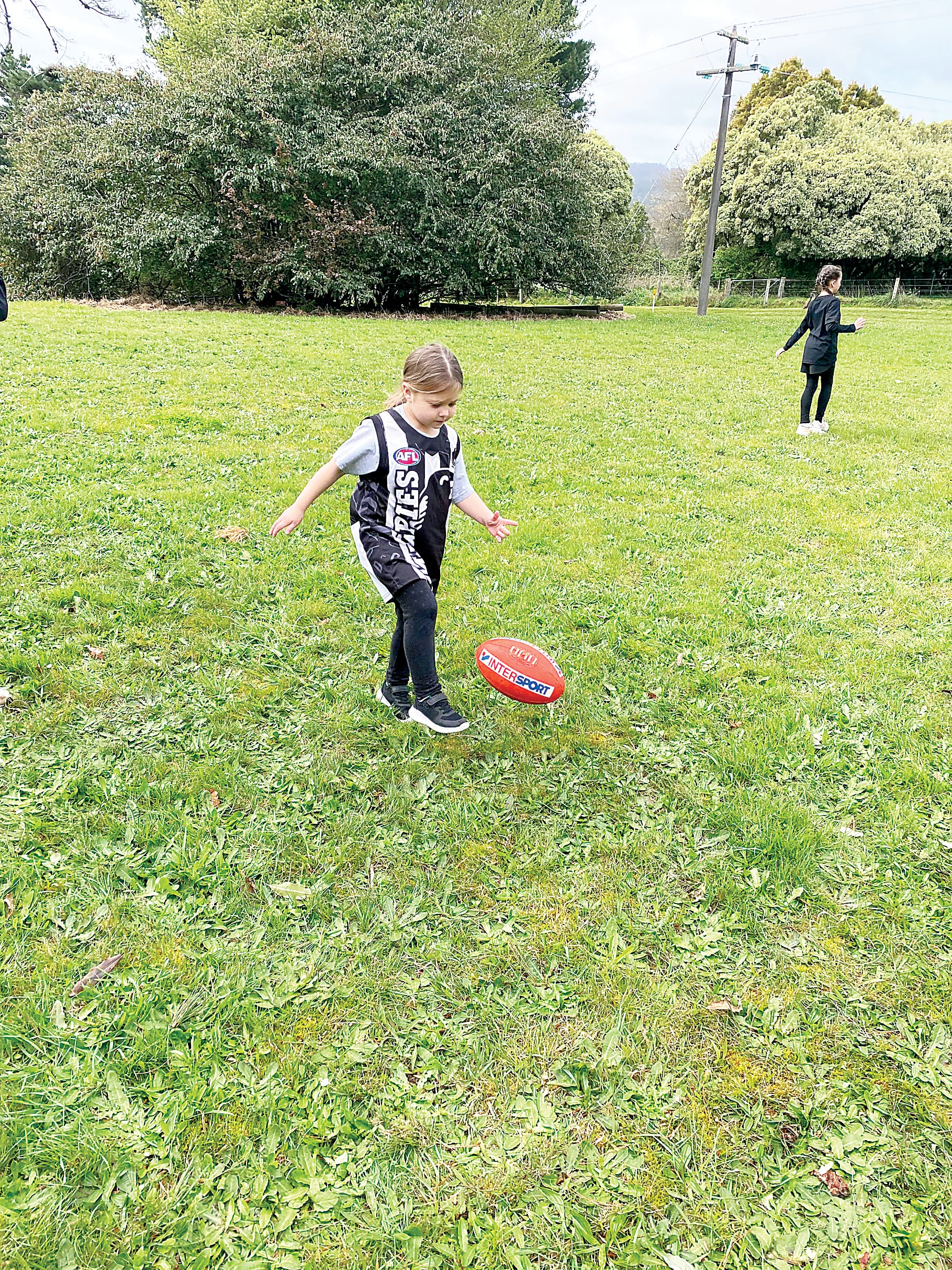 Prep student Madi Ashby learns how to kick a football.